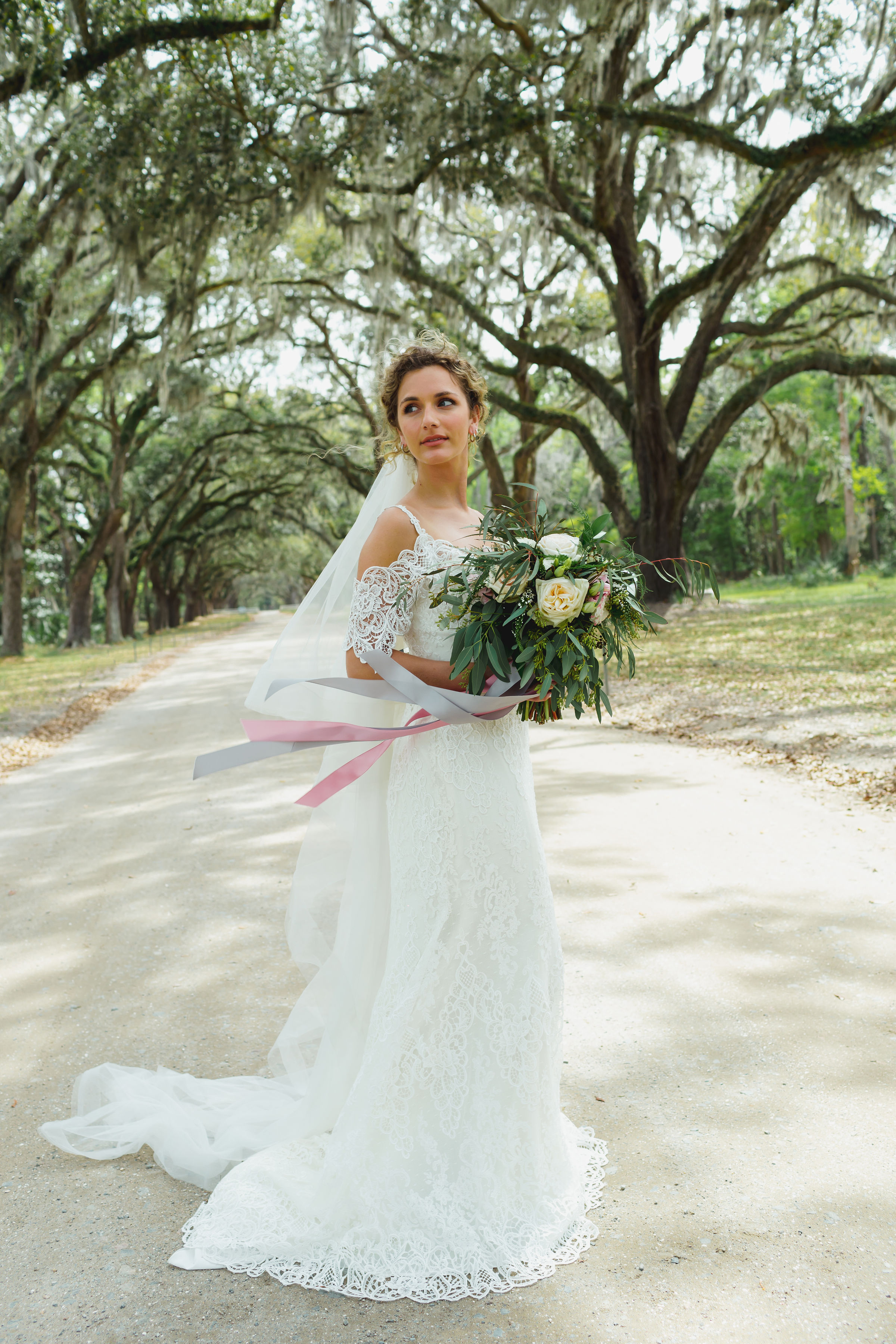 This is the Elliana wedding dress by Maggie Sottero Designs . Don’t you love that off-the-shoulder lace detail?