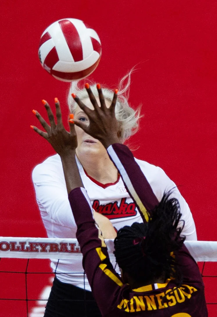  Nebraska's Lauren Stivrins is framed within Minnesota's Adanna Rollins' fingers on Oct. 10, 2018 at Devaney Sports Center. 