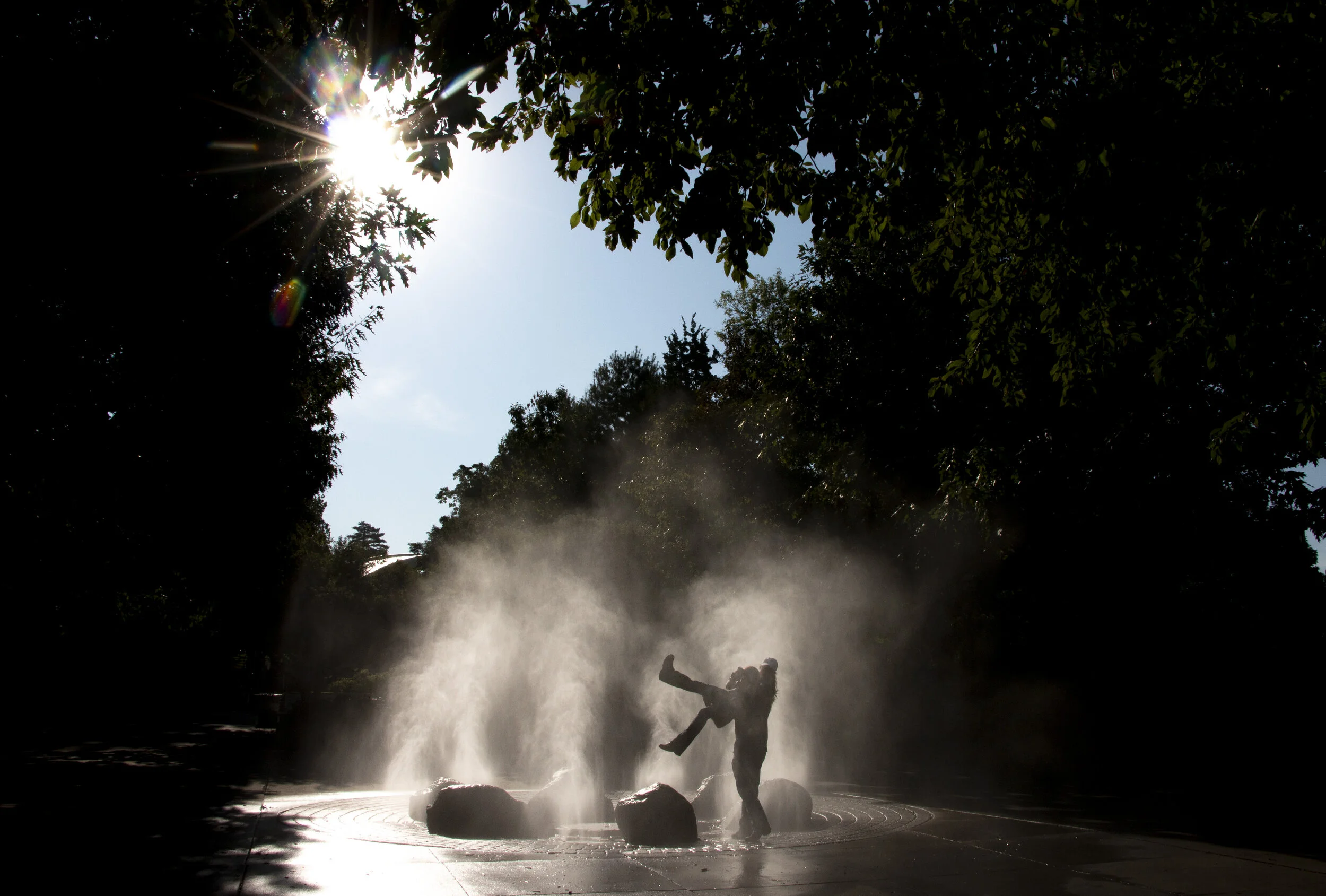  A pair of fairgoers cool off in a fountain at the Iowa State Fair on Aug. 9, 2019.  