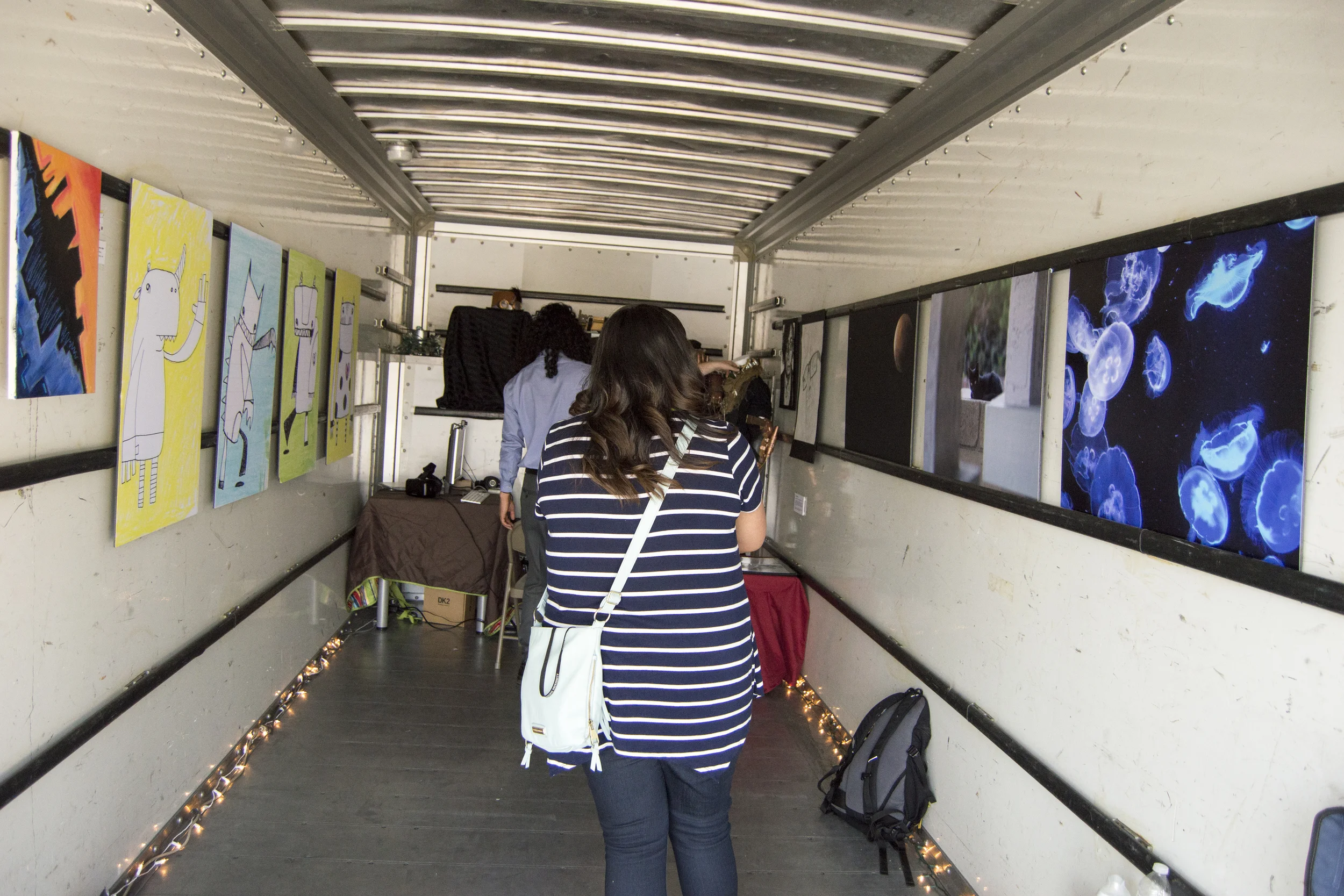 Rosy Razo viewing the art and pondering how the artists made it.