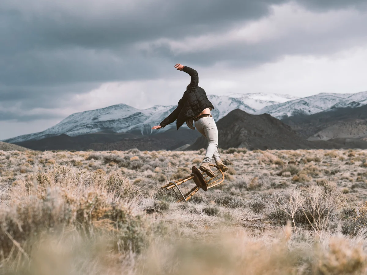 Man falling off of a chair in the wilderness.jpg