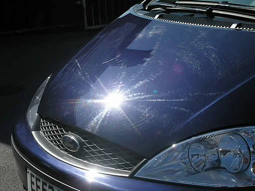 Circular scratching in paint result of auto car washes.