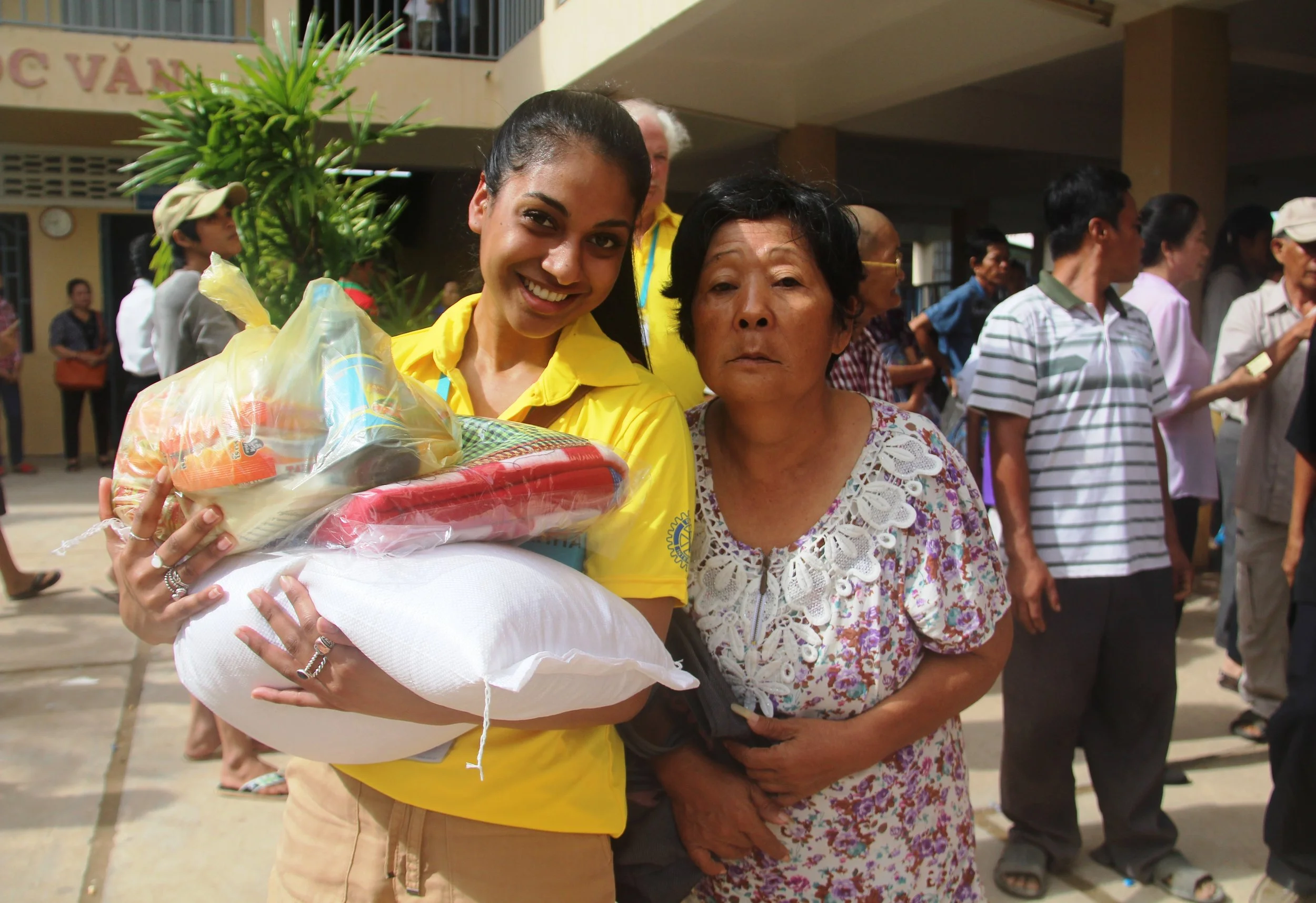 A poor villager receiving food package from AHHA