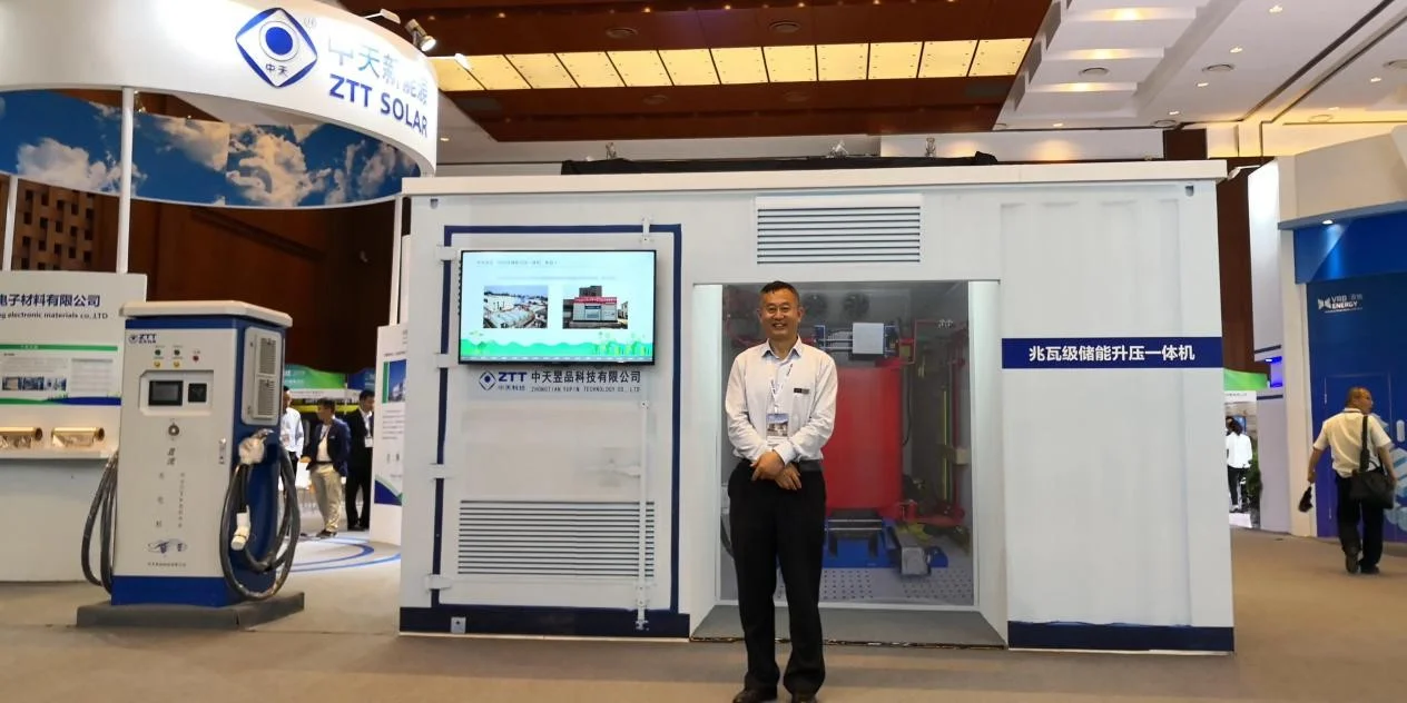 An exhibitor stands beside his product