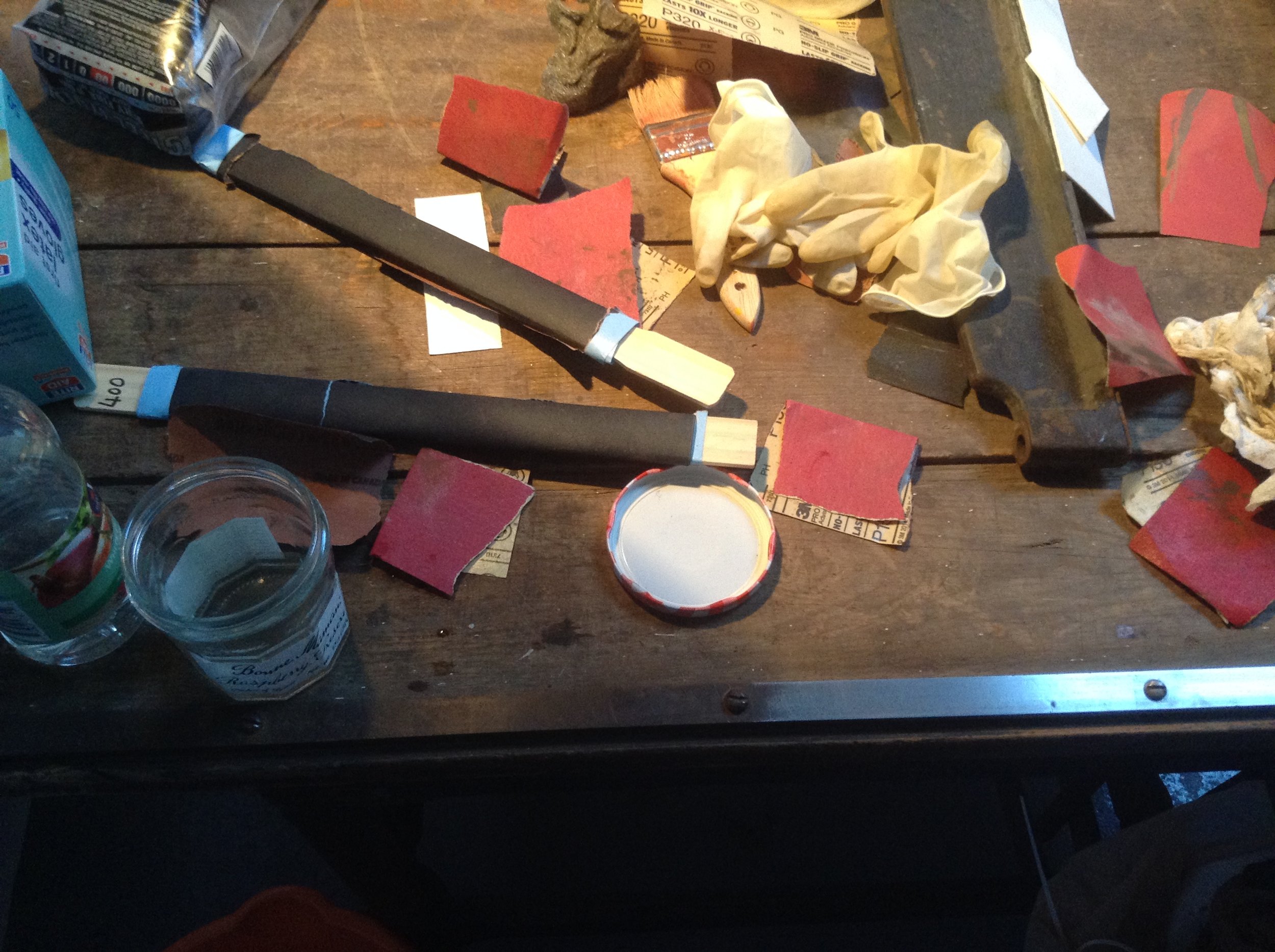  Piles of sandpaper from sanding the rust of the blade. 
