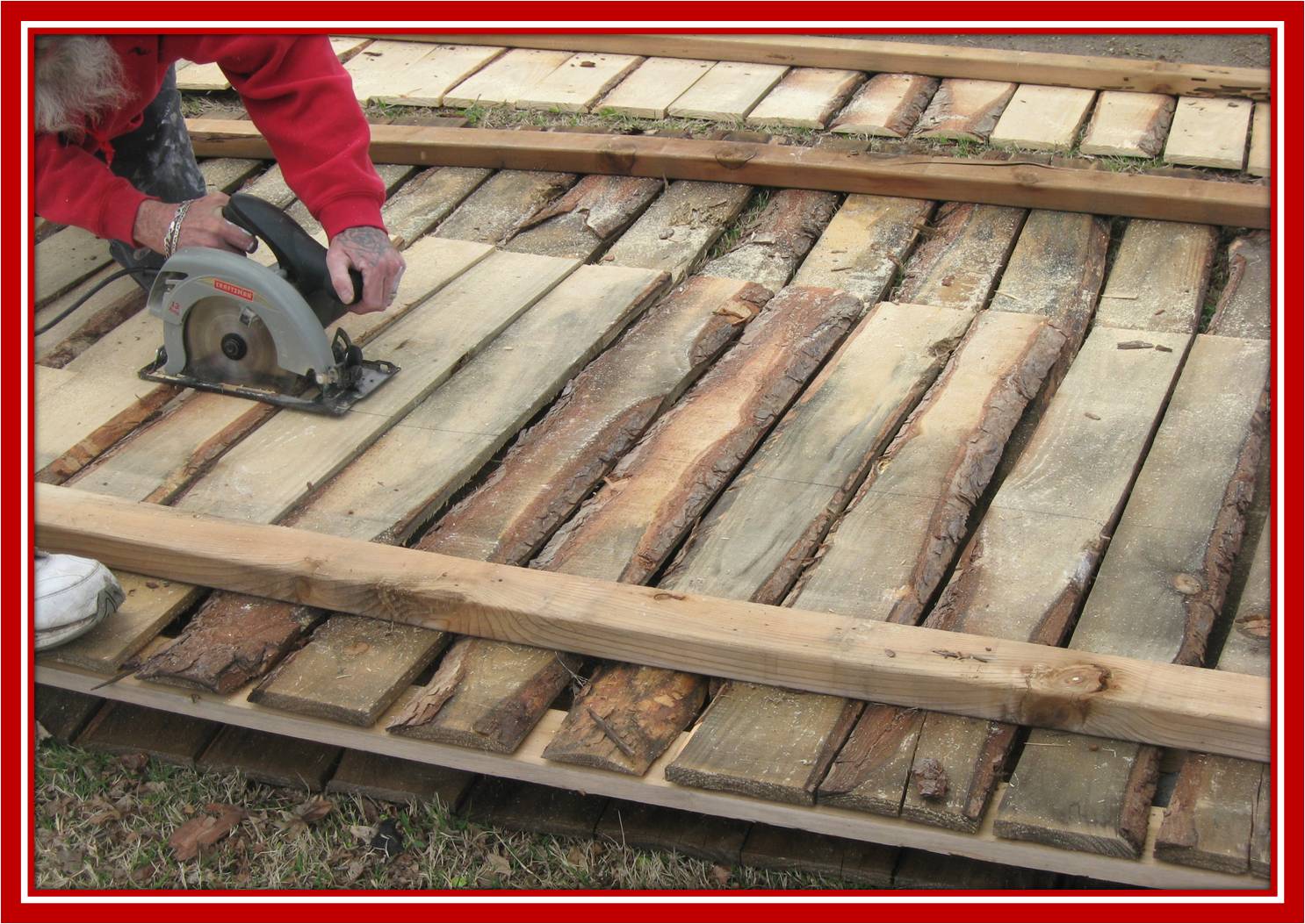 Larry sawing a fence panel
