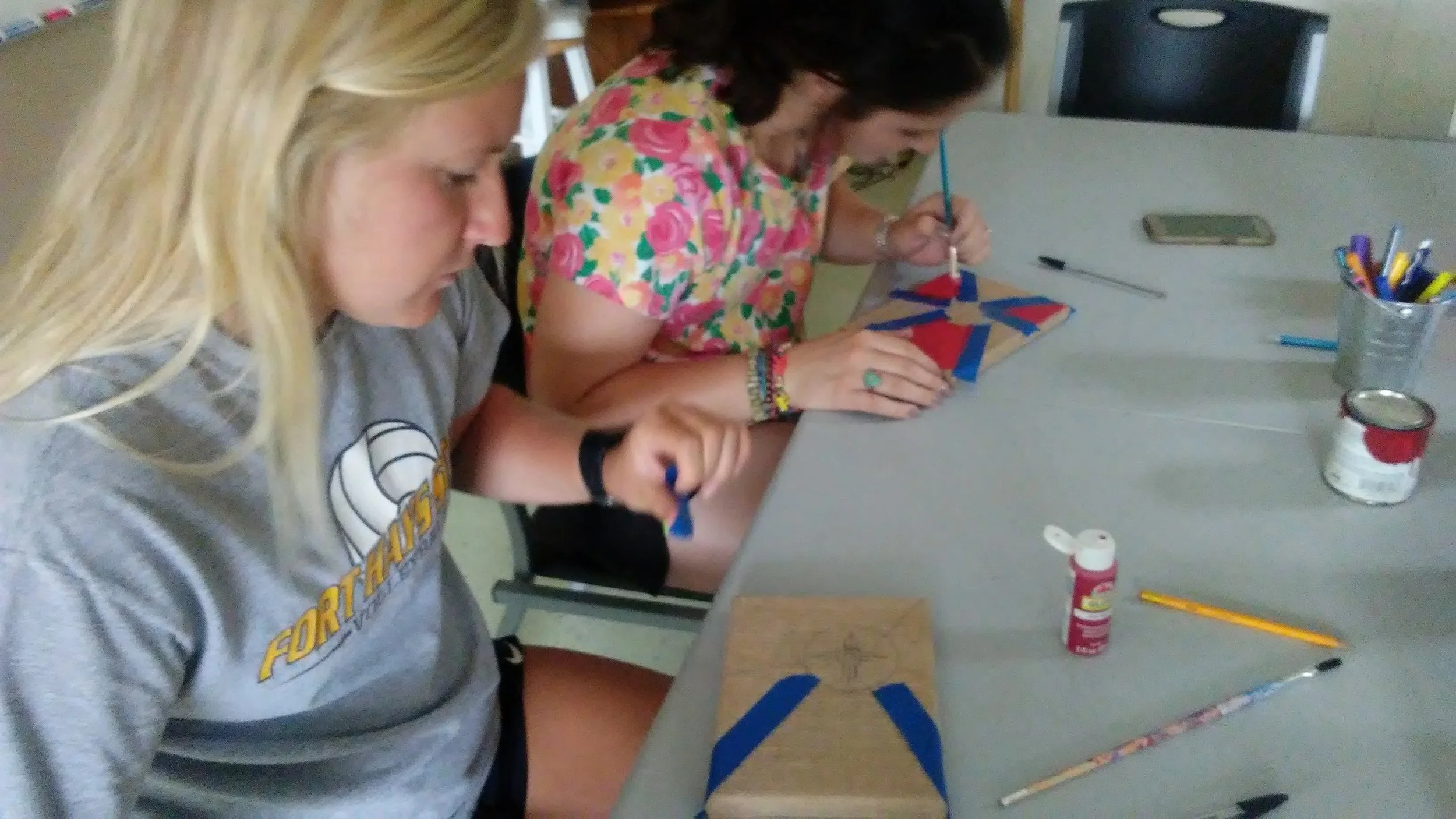 AJ (on the left) making a Wichita flag painting. 