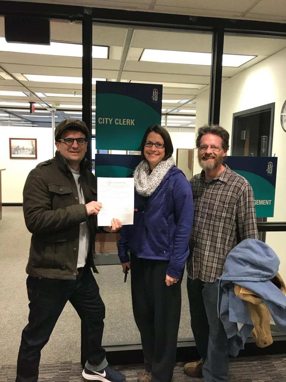 Our team, pictured here with the official paperwork, is ready to get started. 