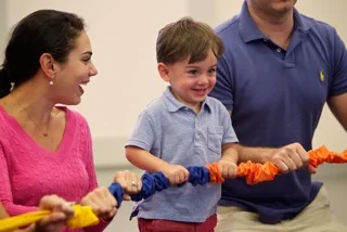 Toddler and Parents With Stretchy Band.jpeg