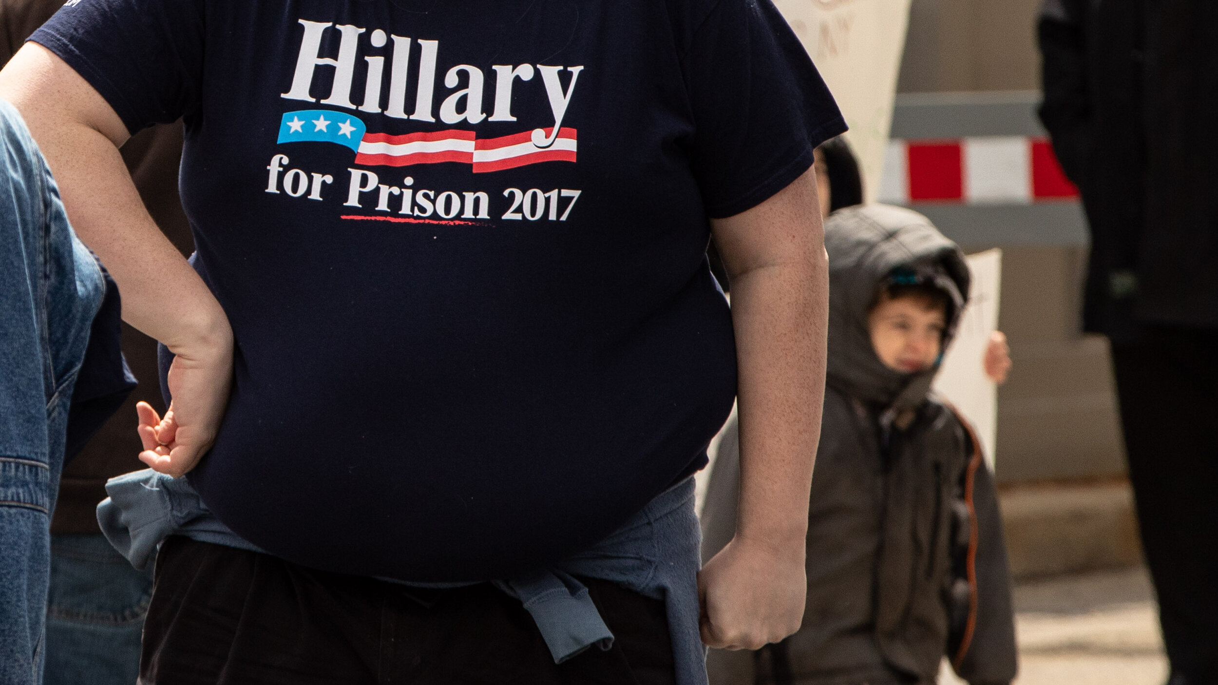  Hillary for prison, with his child behind. 