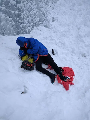 Raf Andronowski waiting for help at the base of Carlsberg Column, outside Field, British Columbia.