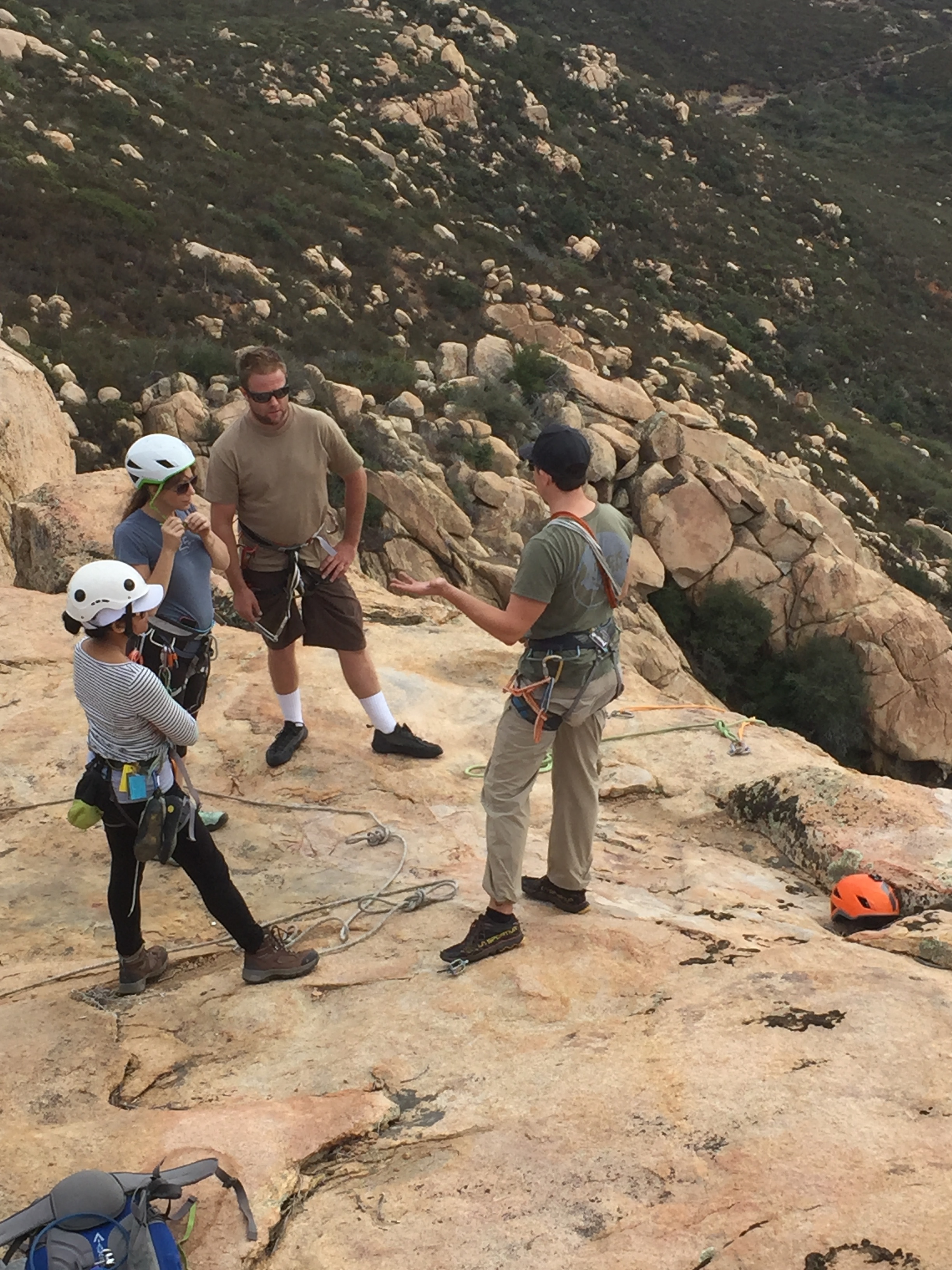 AAC Instructor Tom Vokes talks equalizing anchors and rappelling to AAC Members Melissa Angeles, CJ Hutchens and Toby Hutchens. Photo cred: Piotr Andrzejczak.