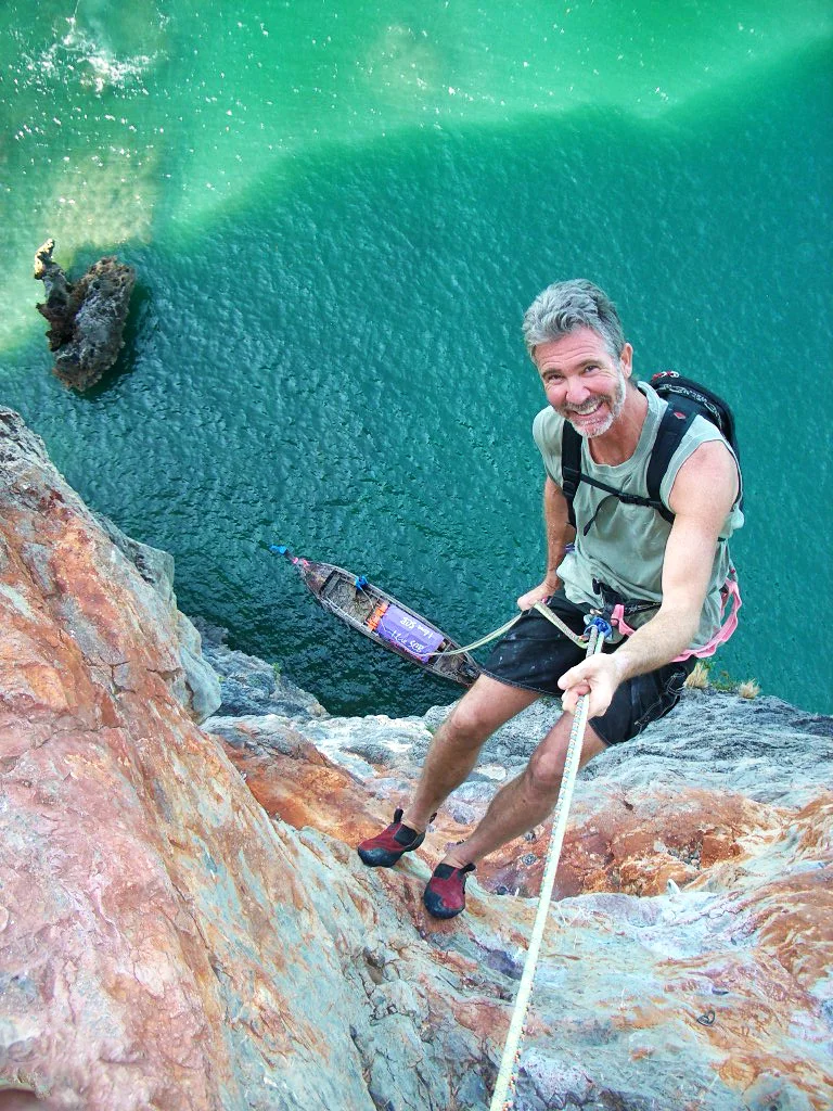 Chris Noble rappels off a climb in Thailand. 