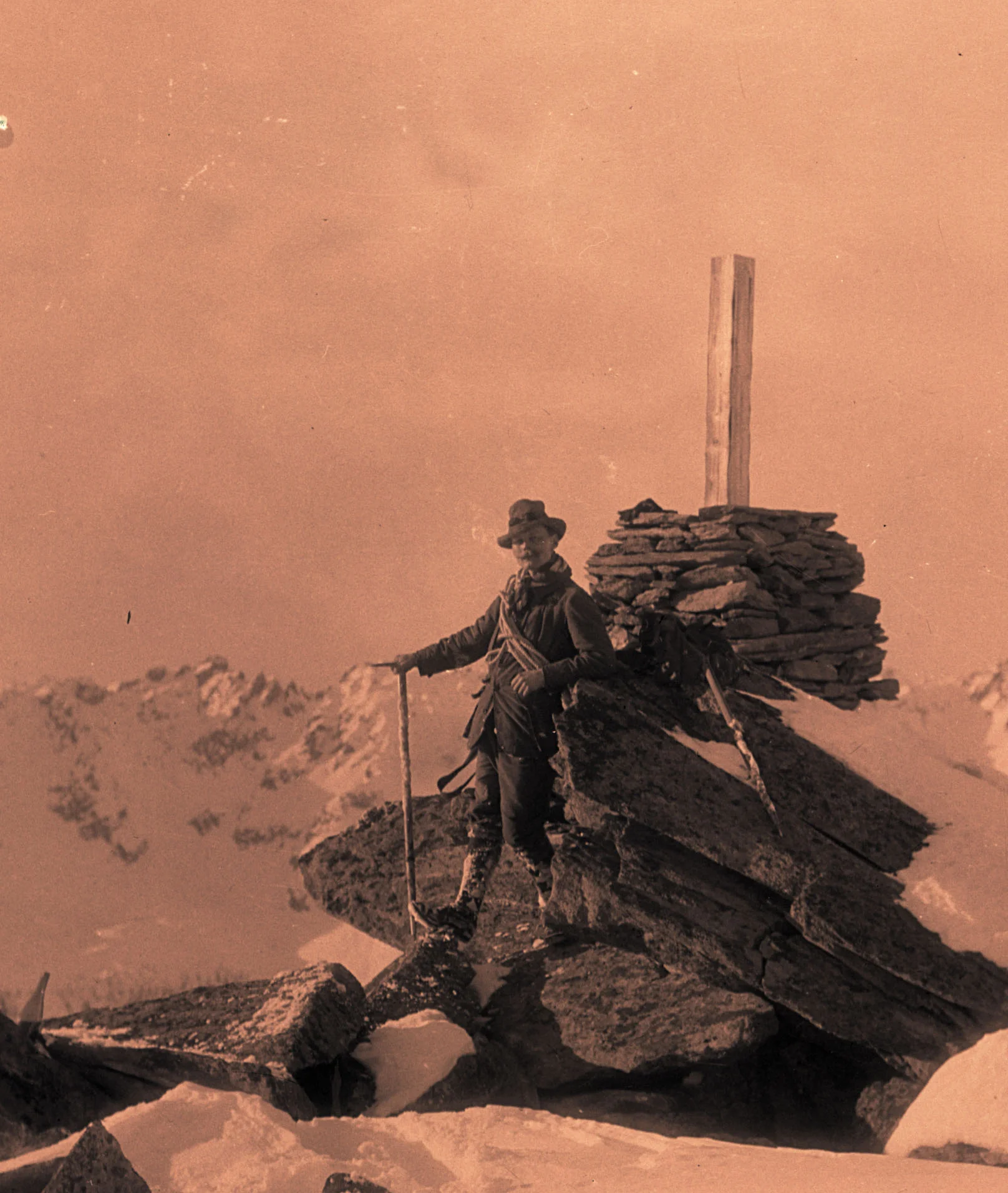 Andrew James Gilmour posing with an ice axe on a summit.
