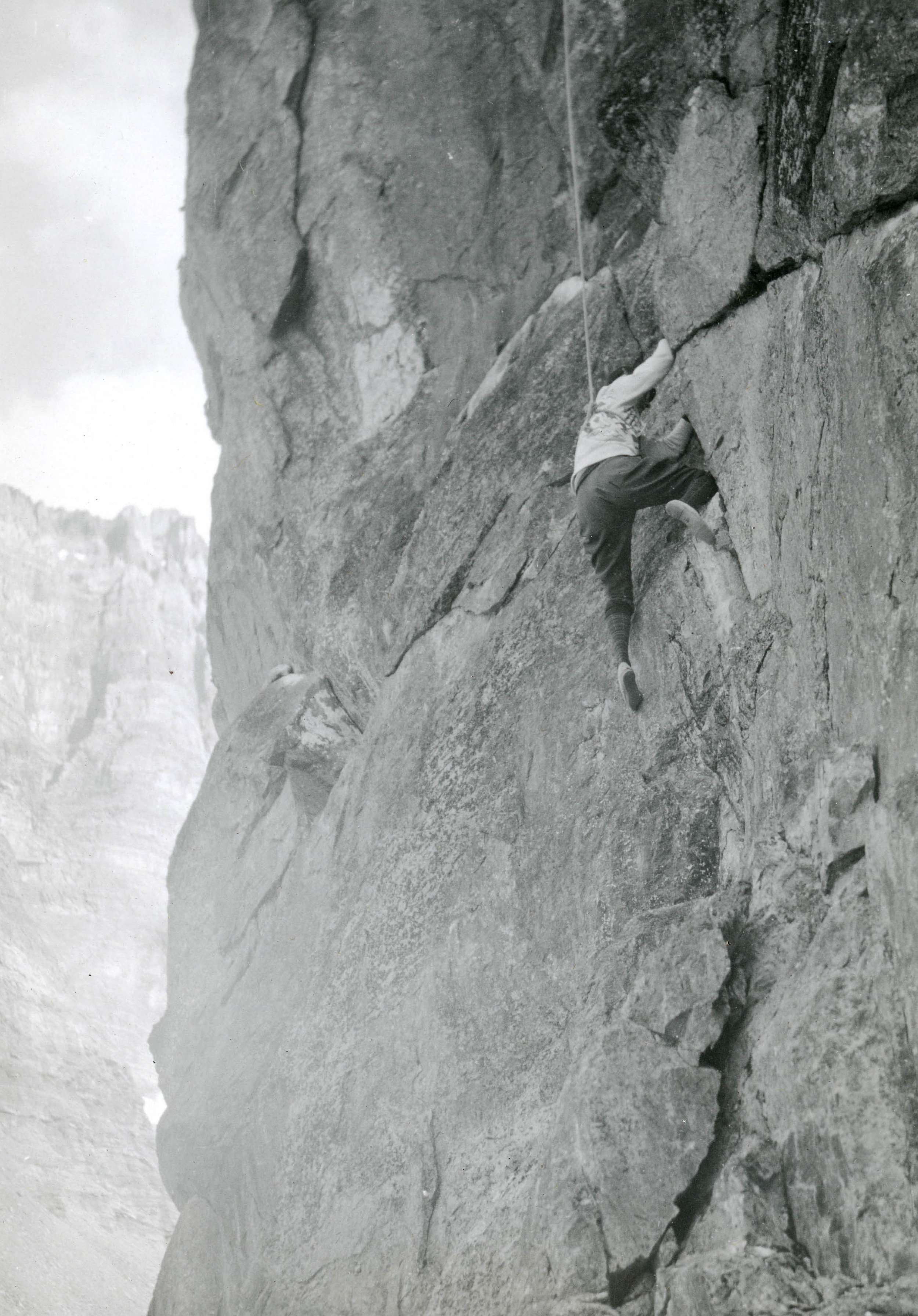A woman makes her way up a rock face