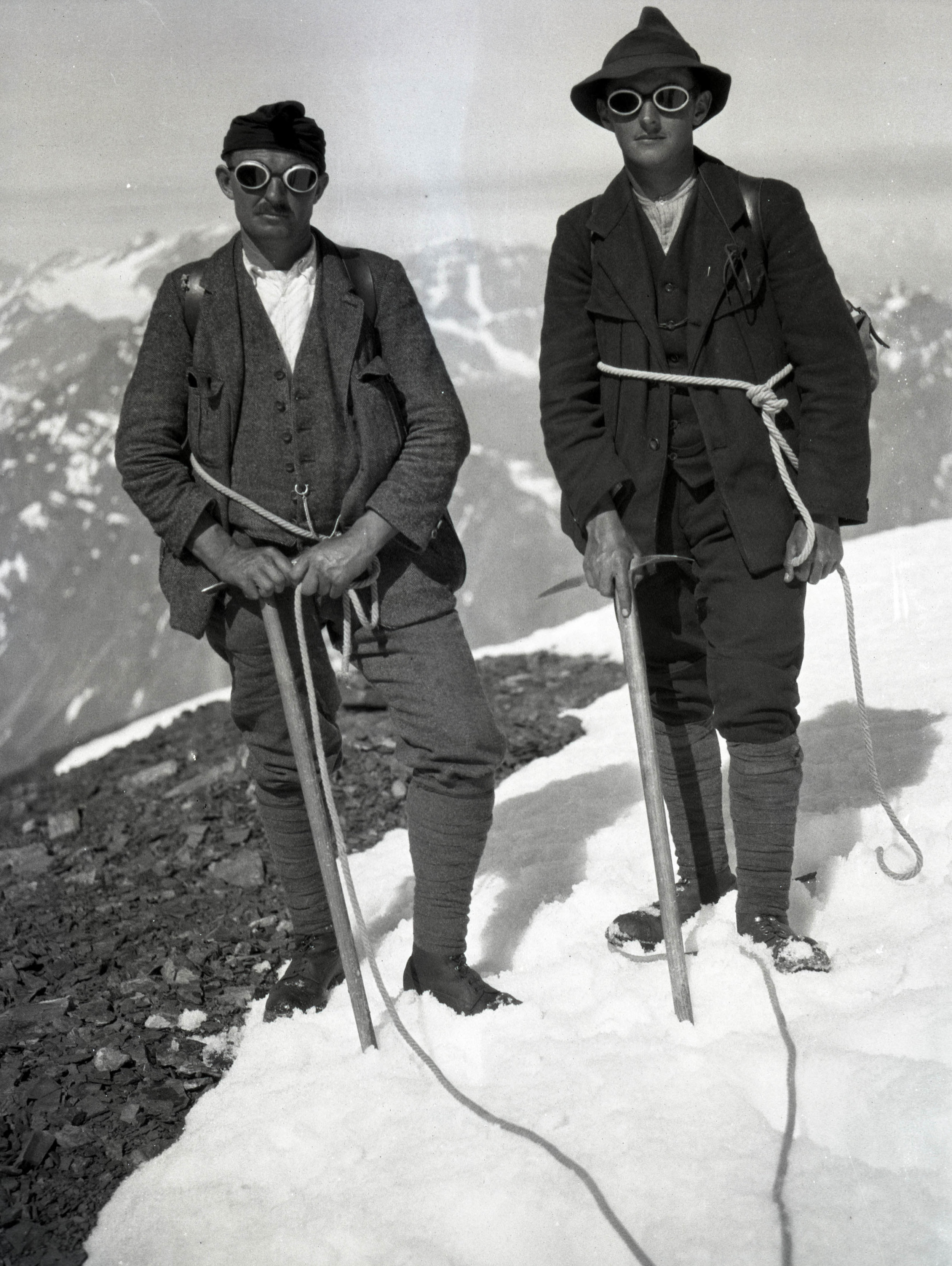 Hemp rope, ice axes and glacier goggles. These two climbers are also wearing puttees (leg wraps).
