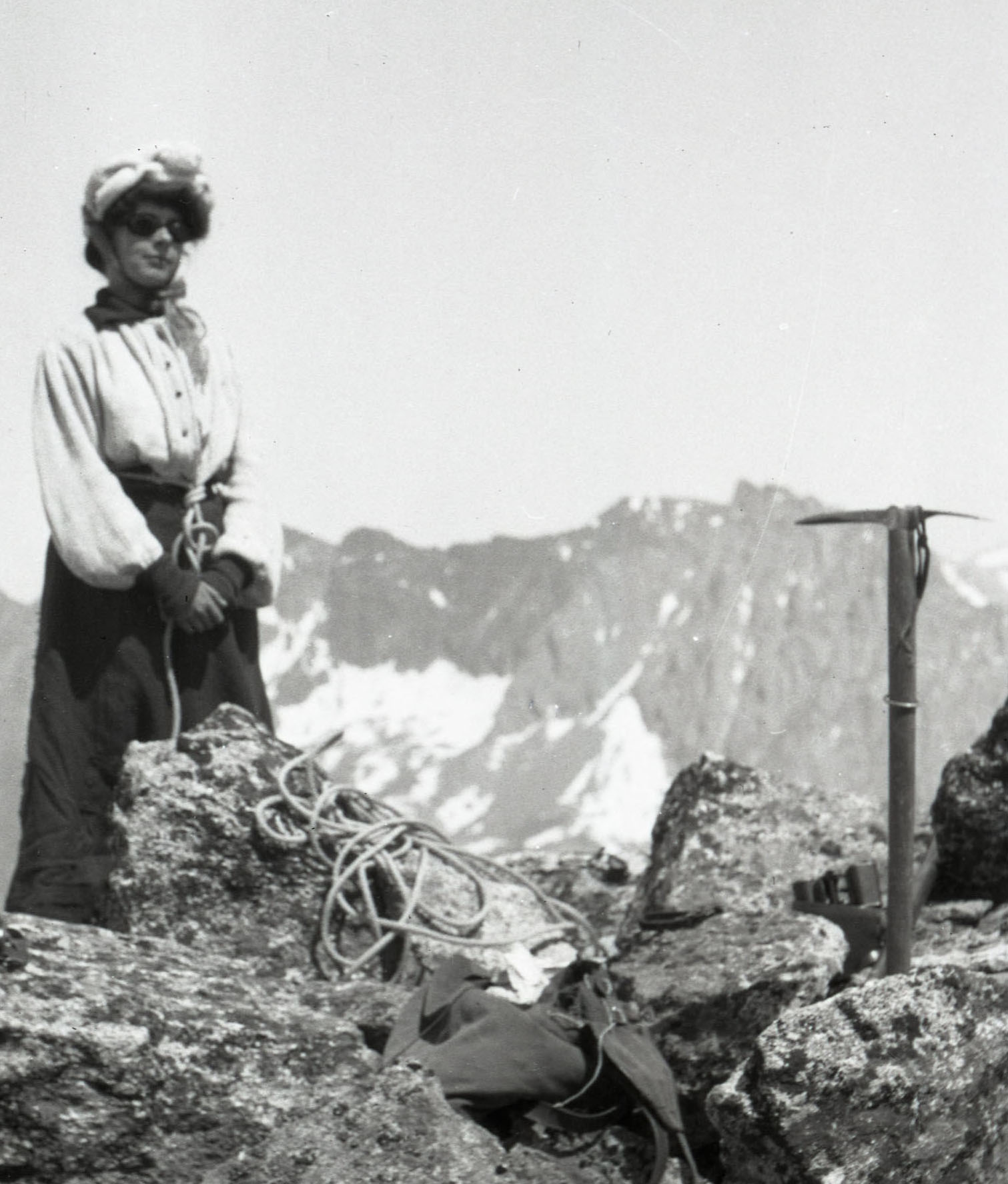 A woman summits in the Alps
