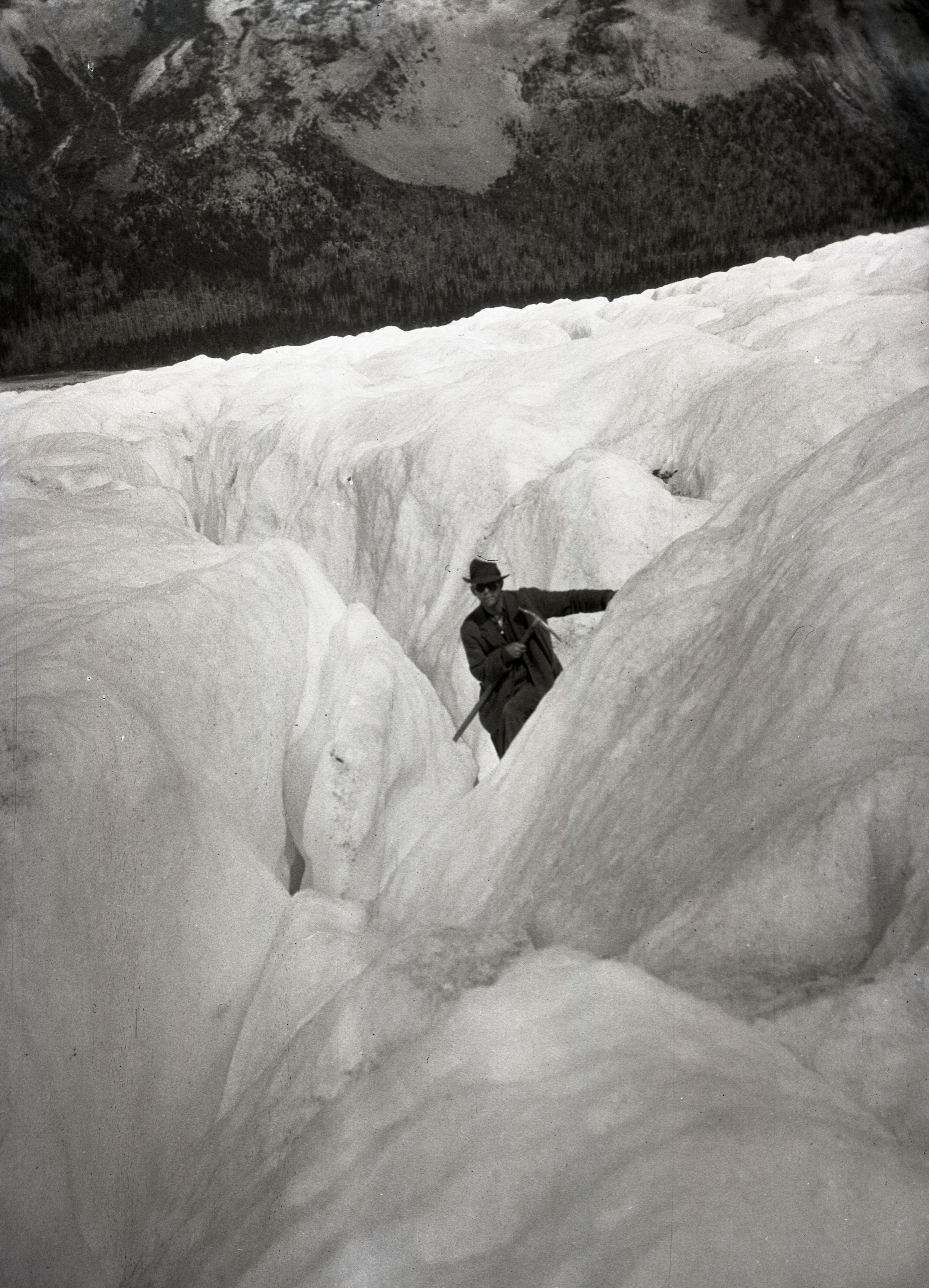  A man making his way through a crevasse on Robson Glacier, Mount Robson 