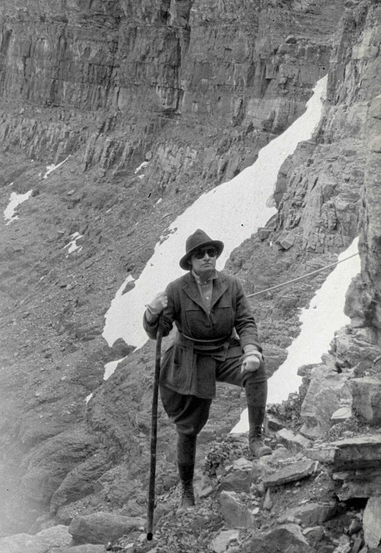 A woman roped off and ready to climb