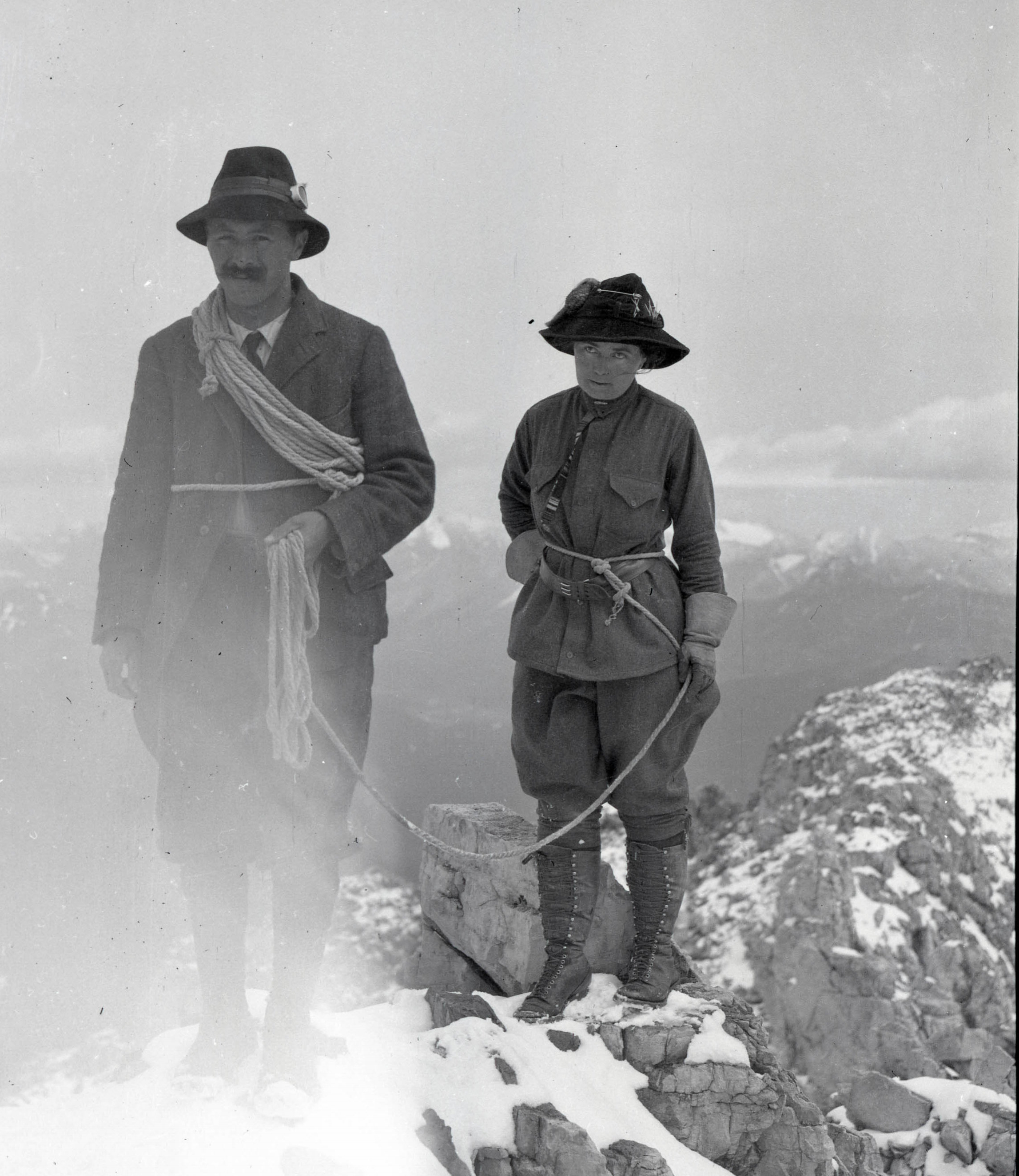 A man and woman celebrating on a summit.