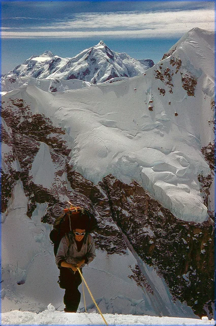 Pete climbing the fixed rope carrying a load of gear.