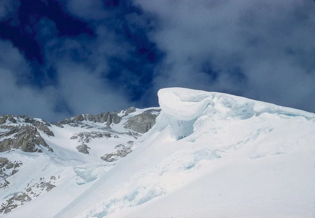 We were soon over the saddle and cutting our way up the Second Bump, where we were able to avoid the steep lower section on its west side. After two rope lengths on this Bump, threatening weather and the knowledge that the route was possible turned us back.