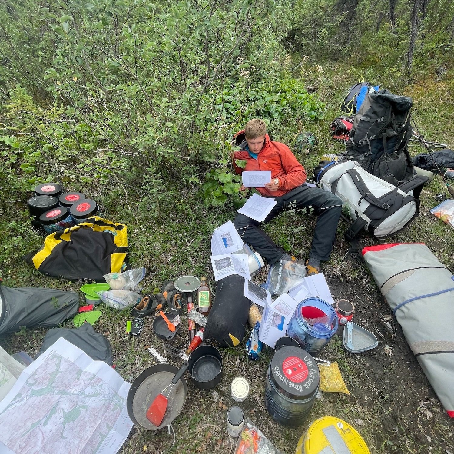  Studying the maps amid an explosion of gear at Circle Lake, gateway to the Arrigetch. 
