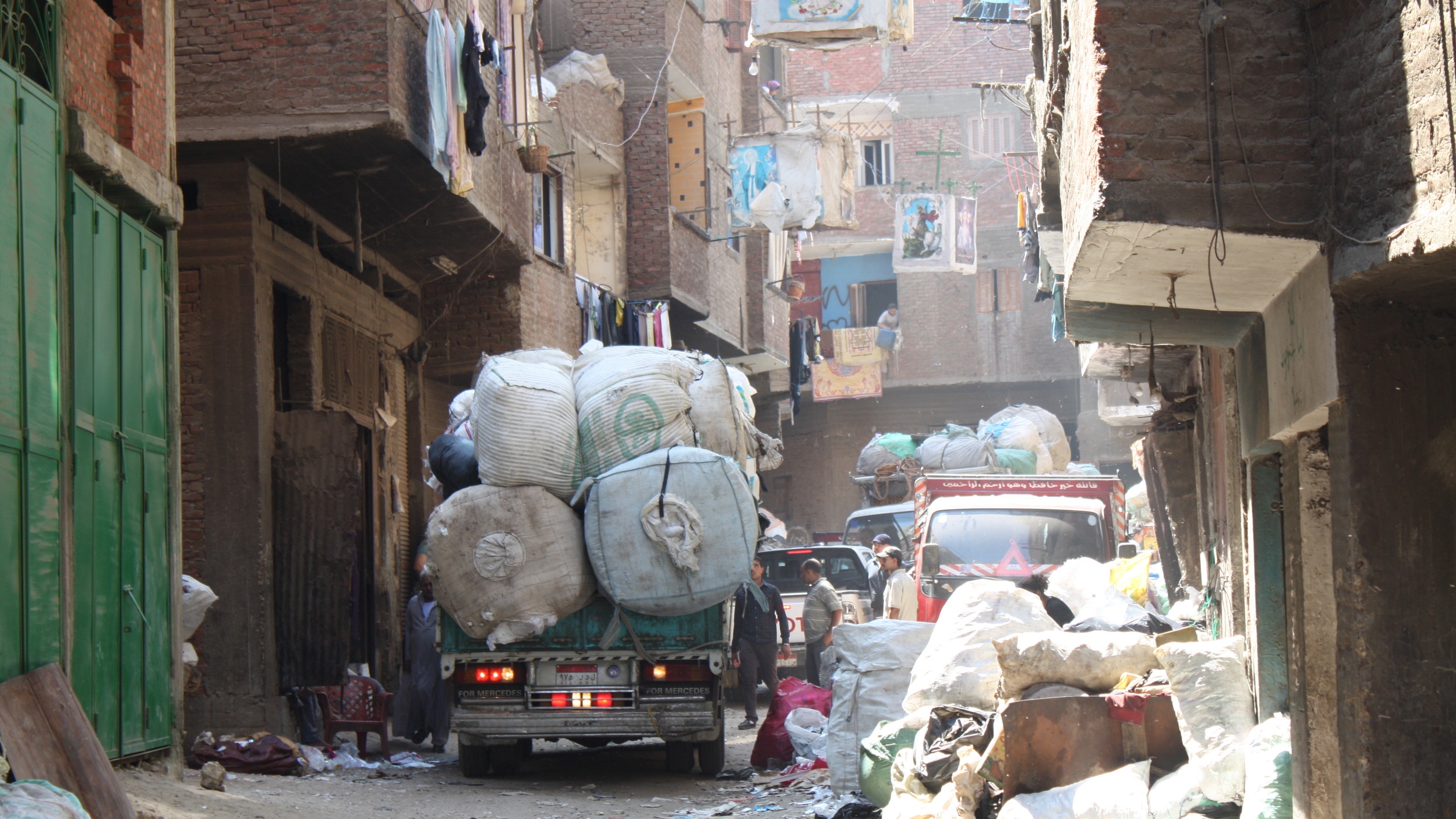 A Zabaleen garbage truck driving through Mokattam, Cairo (Source: Wikimedia Commons )