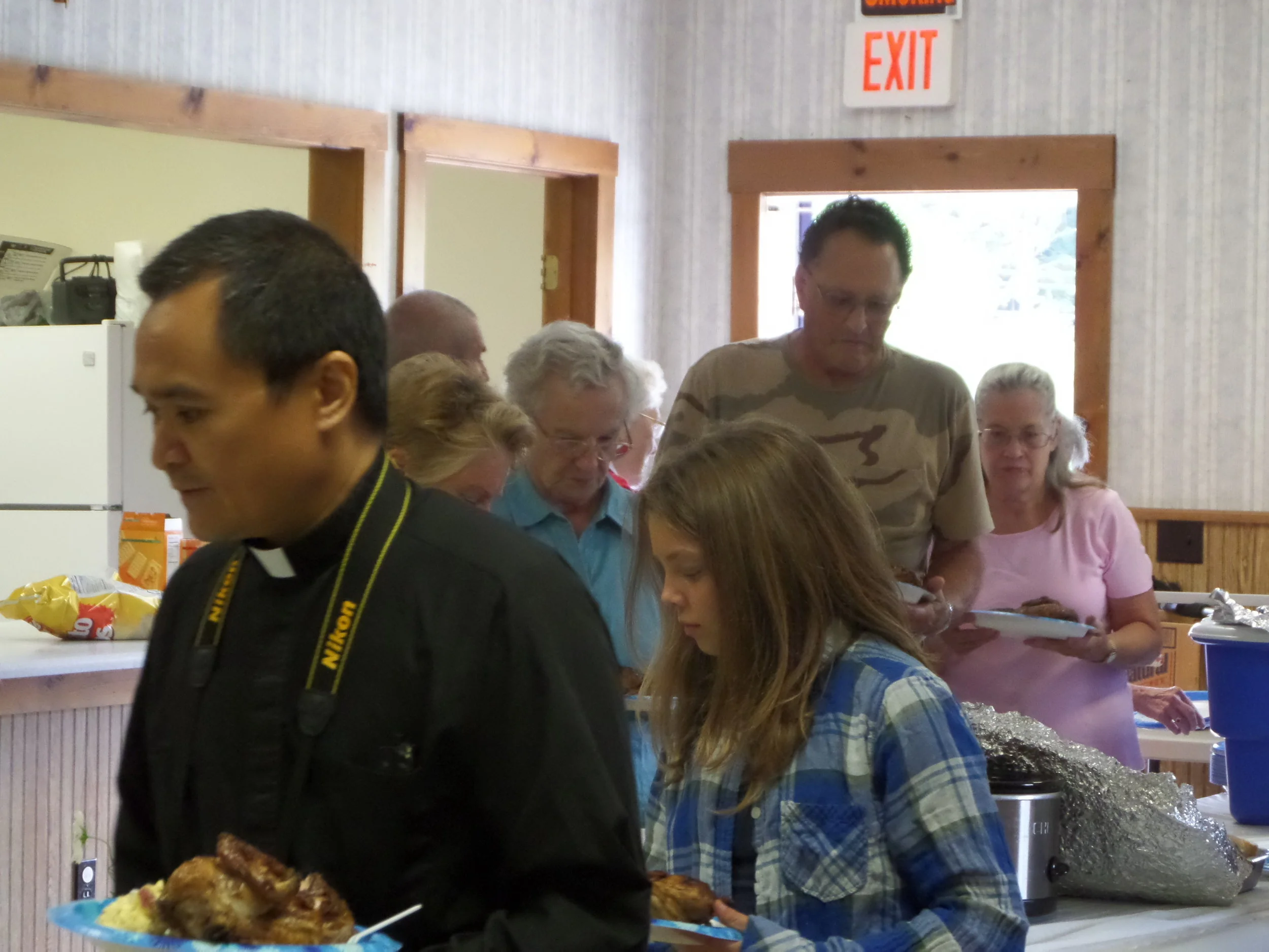 Fr. Lito grabbing some delicious barbecue at the Parish Picnic August, 2016