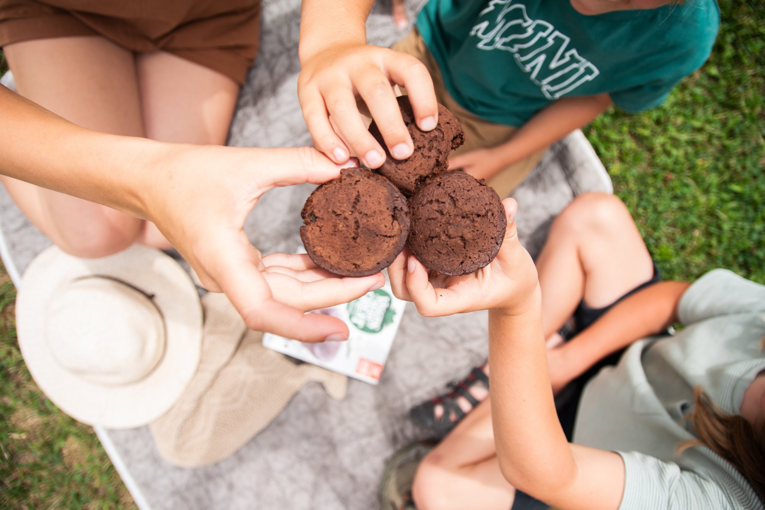 hands cheering with chocolate muffins