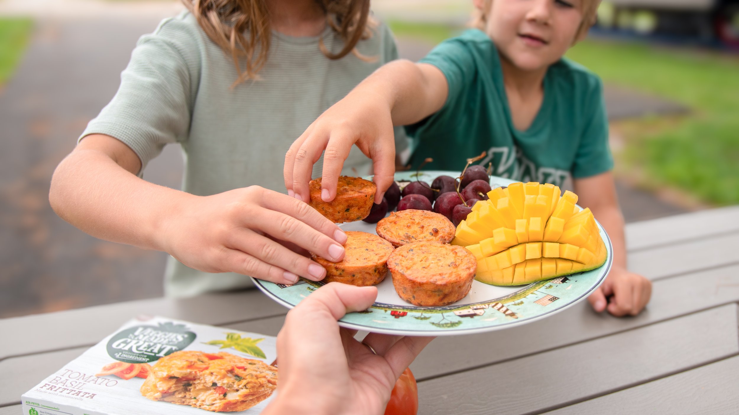 children grabbing frittatas from plate