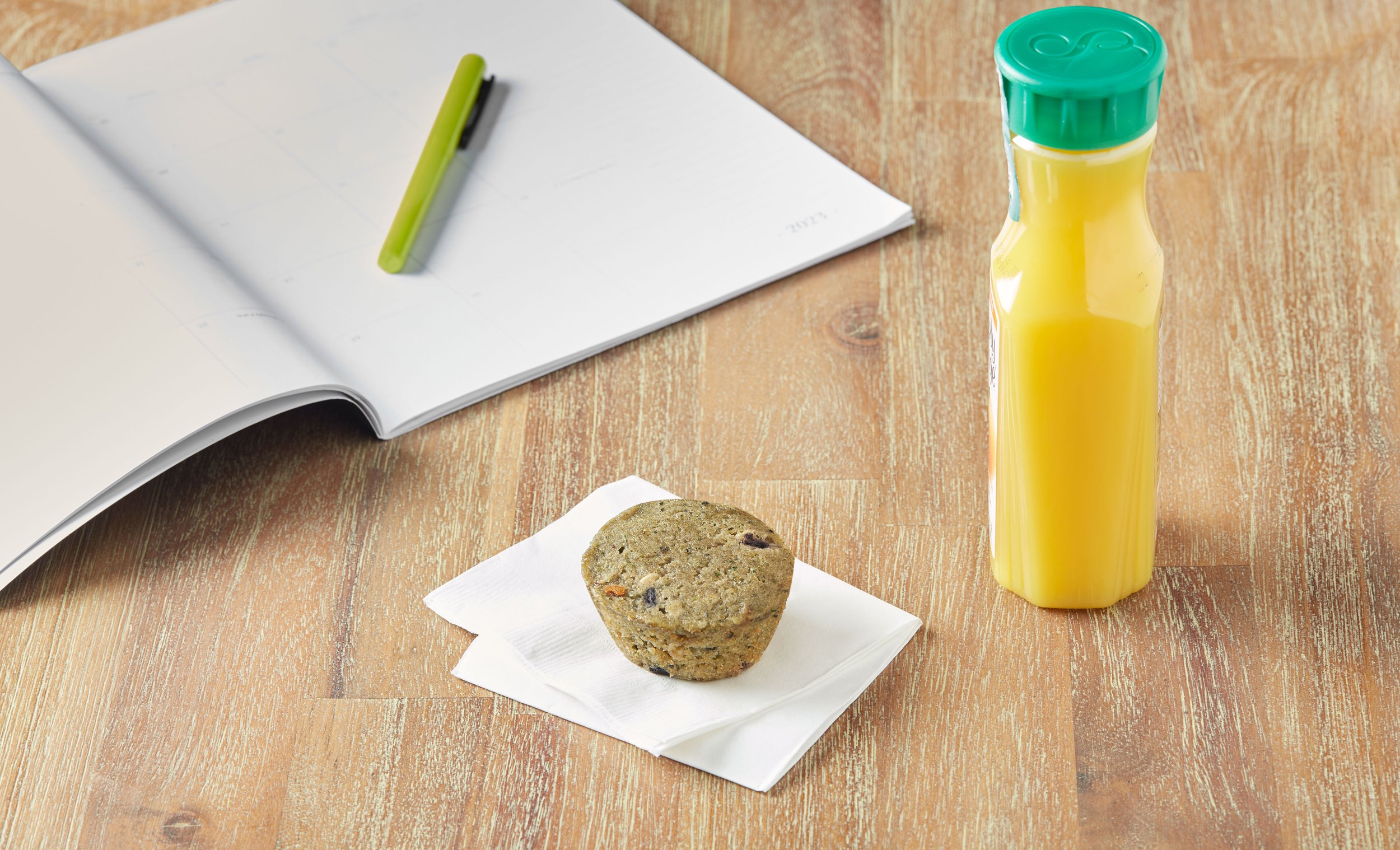 muffin on napkin with orange juice