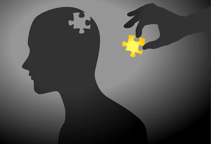 Silhouette of man, other person adding missing piece to puzzle.