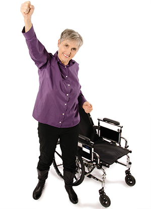 Dr. Terry Wahls standing in front of her wheelchair.