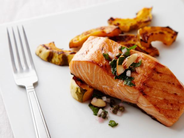 Piece of cooked salmon on a plate. This salmon is full of omega-3 fatty acids that can help fight depression.