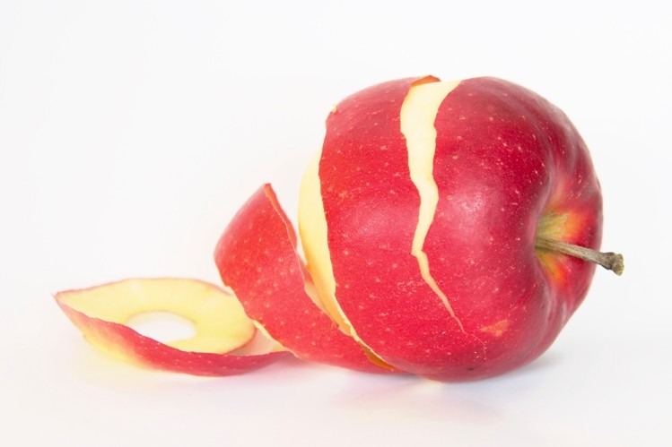 An apple partially peeled. Apple peels contain ursolic acid, a natural compound that can increase IGF-1 levels.