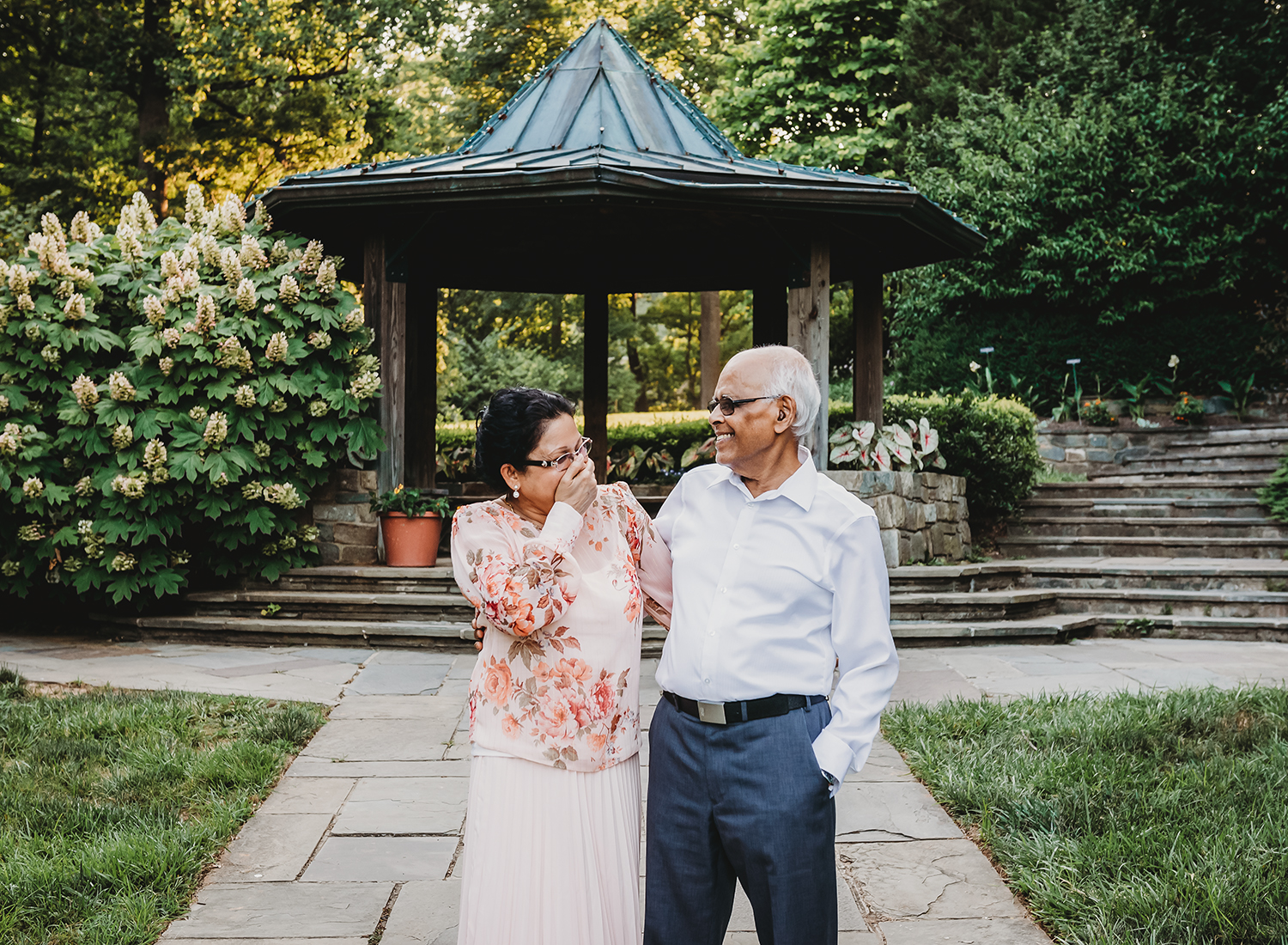 grandparent laughing at each other at gardens in maryland.jpg