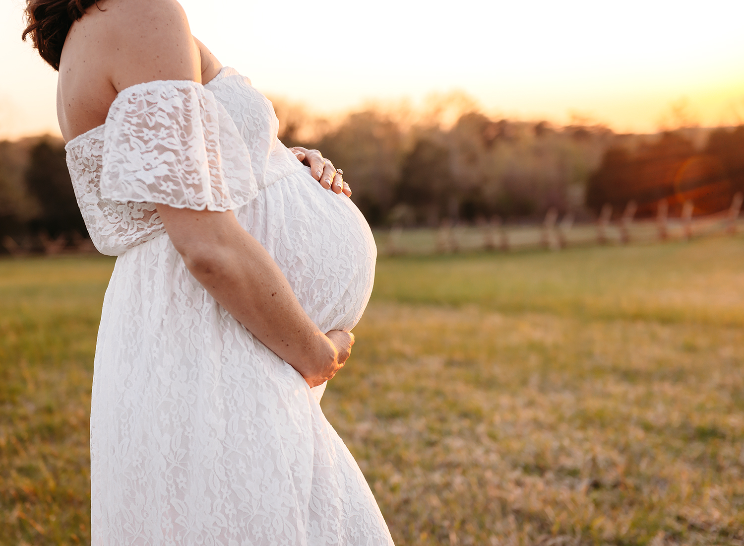 maternity session close up of moms baby bump at golden hour.jpg