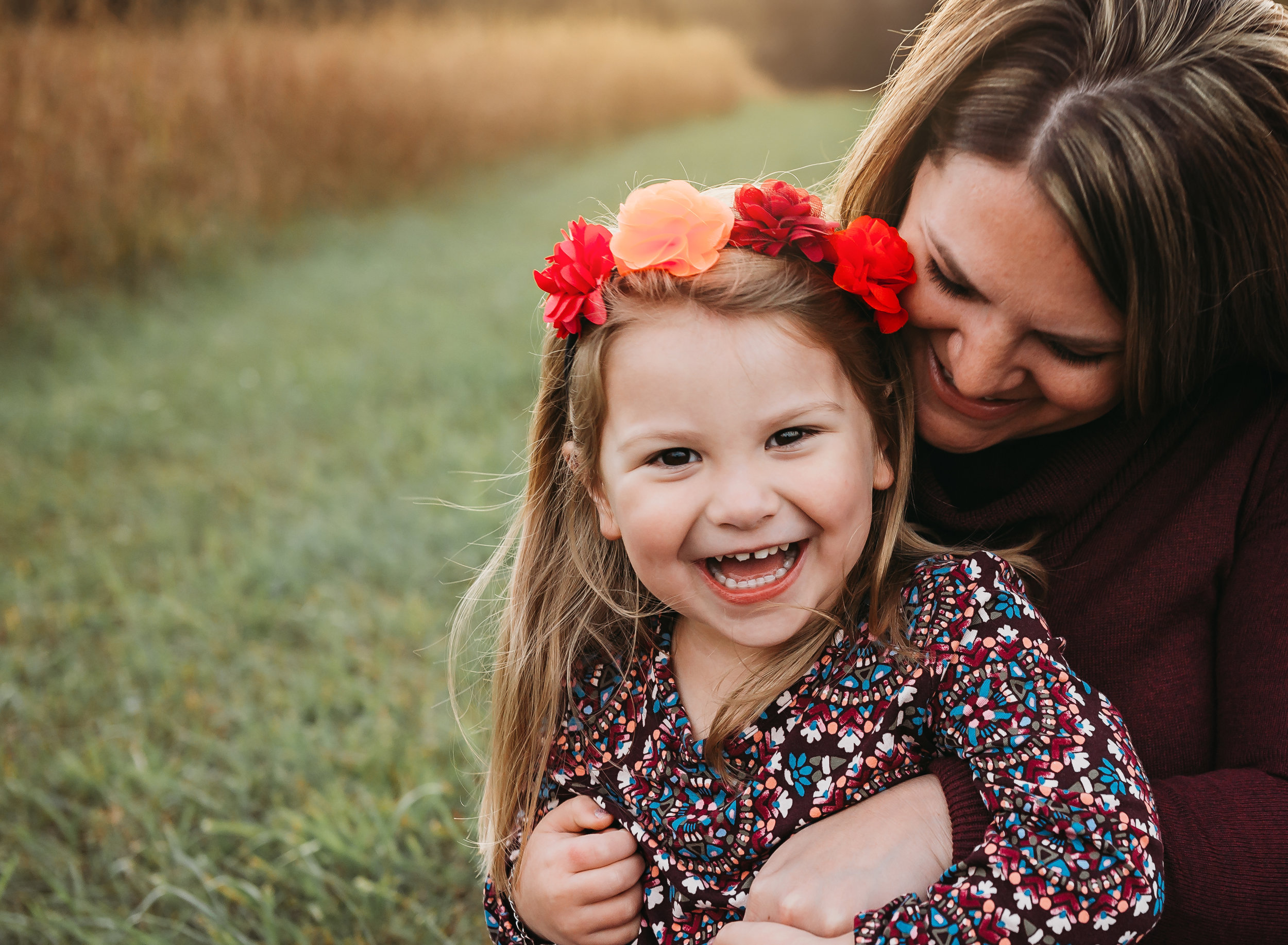 mom and daughter having fun in field during Northern Virginia fall family mini session