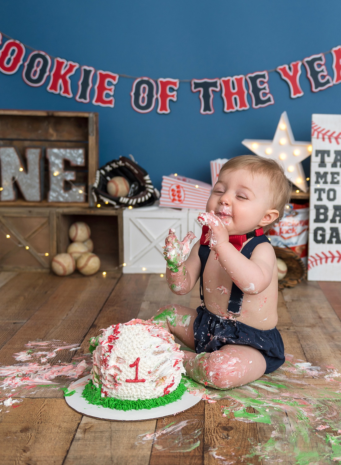 baby eating and having fun with baseball cake.jpg