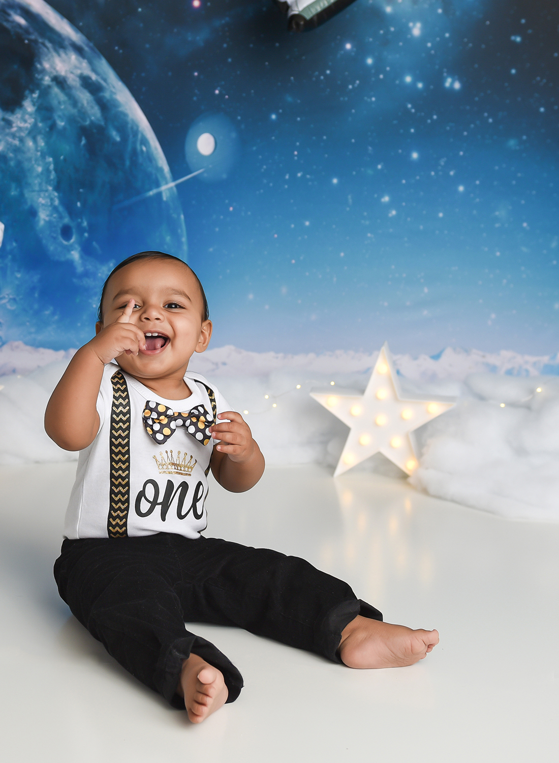 space ship solar system cake smash with baby pointing.jpg