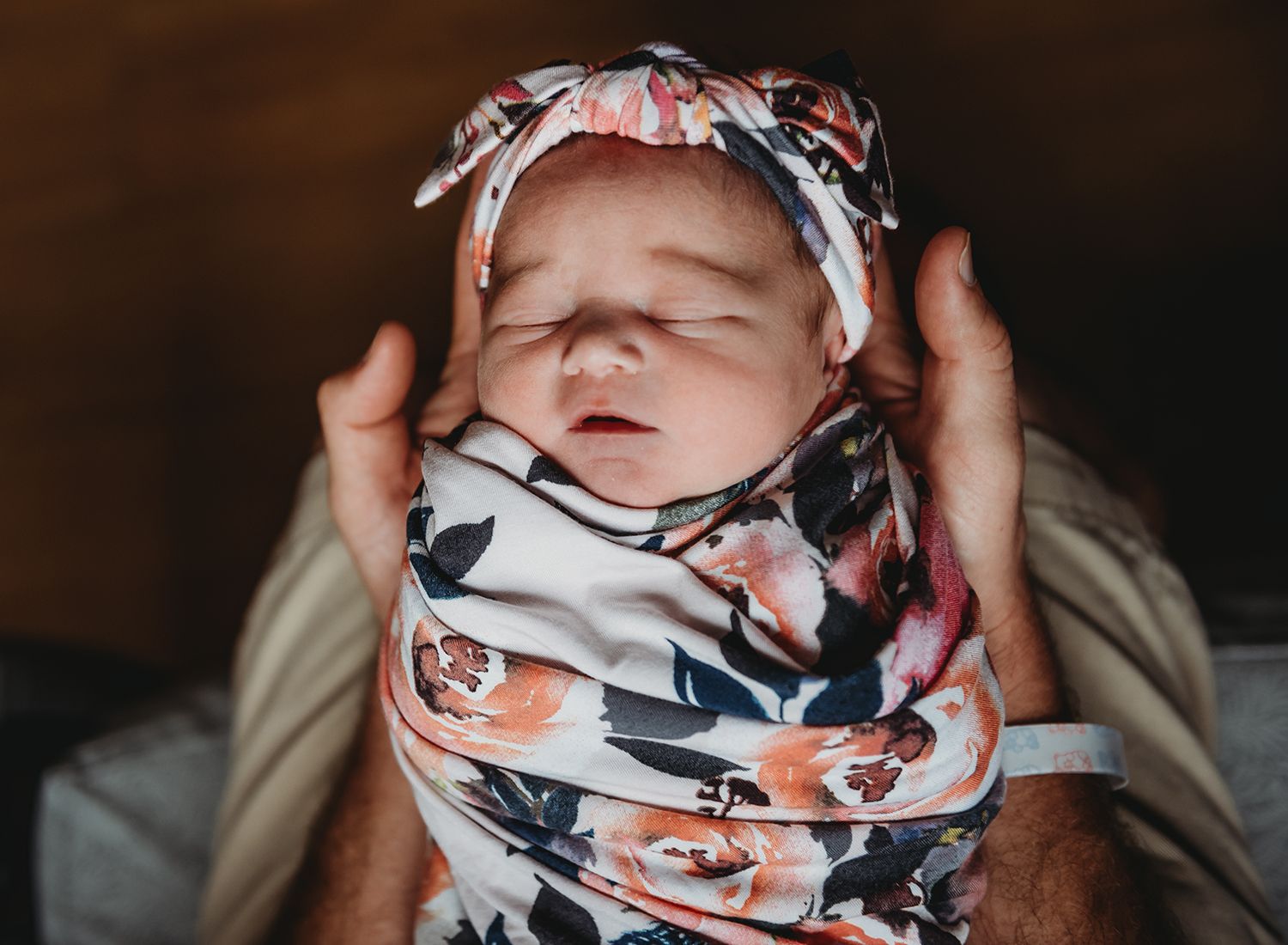 newborn baby sleeping in dads hands.jpg