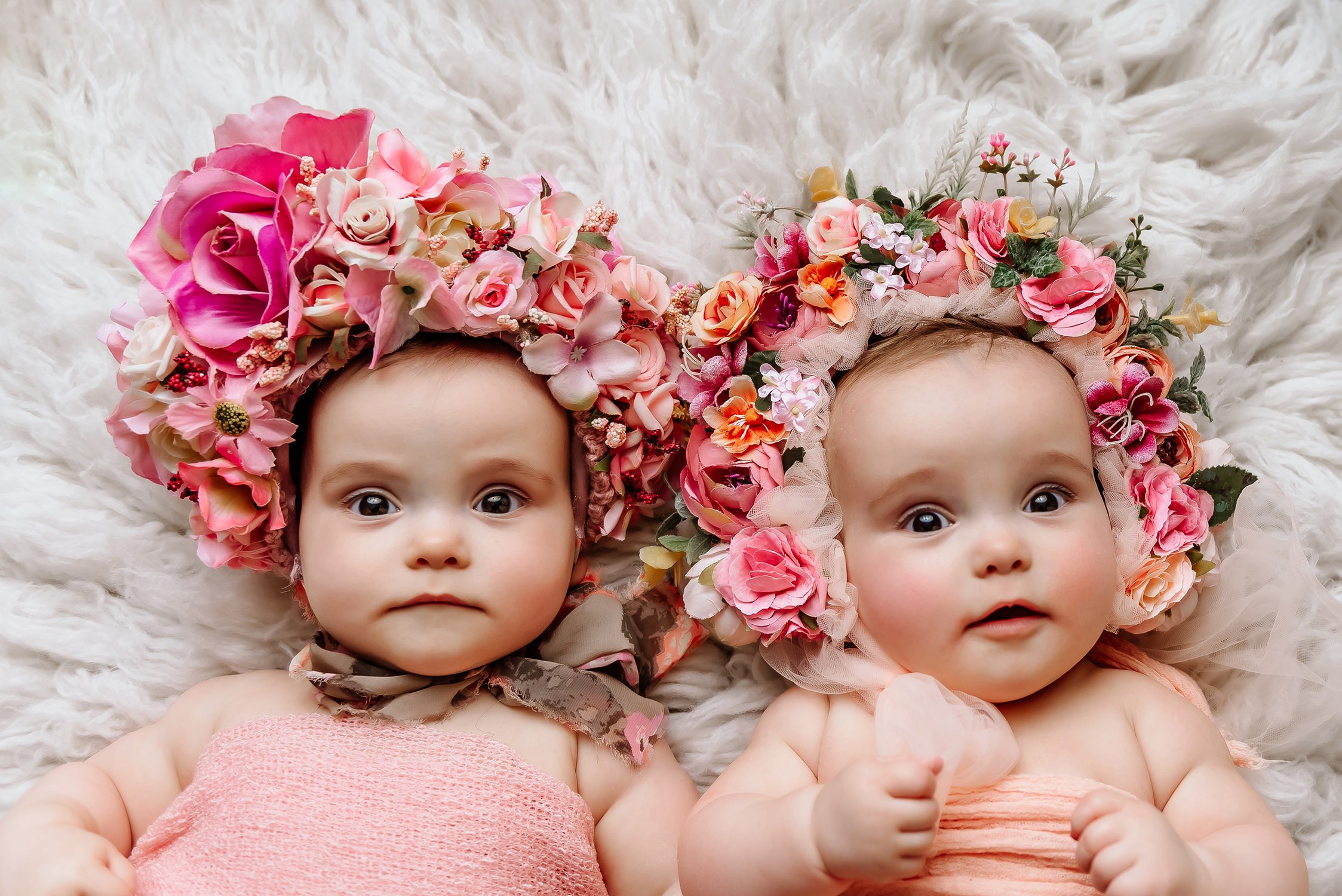 twins girls milestone seven month session wearing flower bonnets.jpg