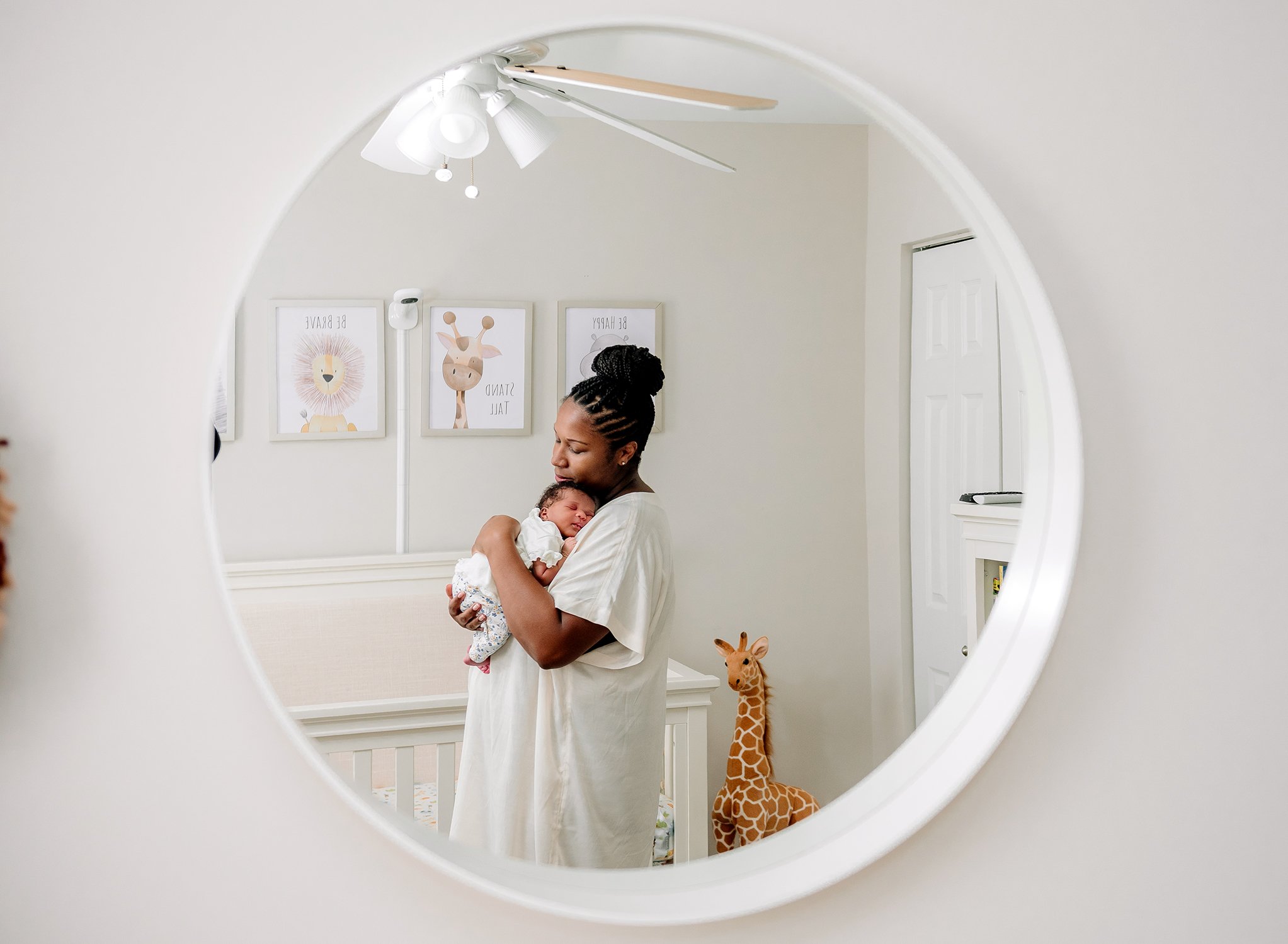 newborn in mothers arms reflection in mirror.jpg