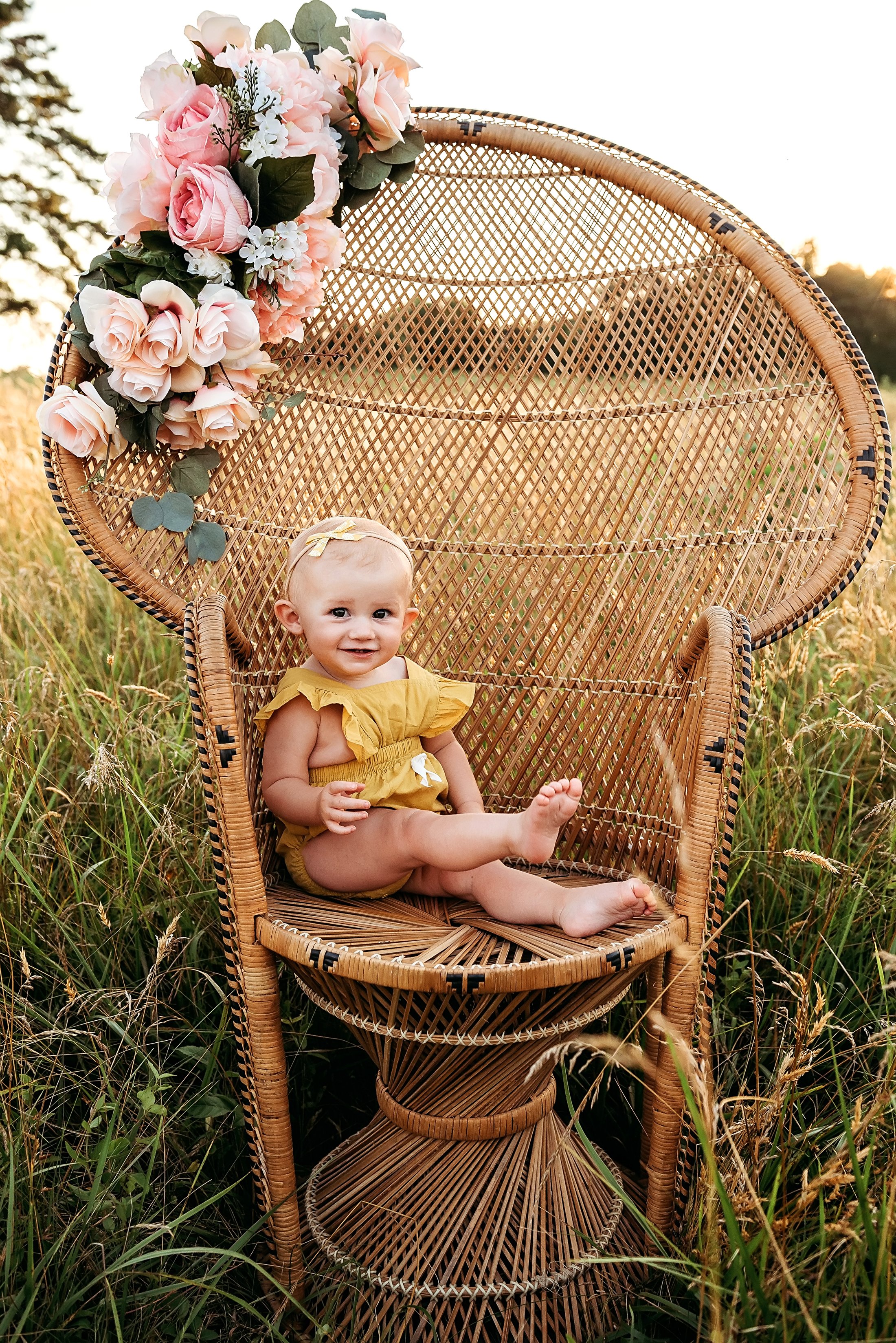 baby sitting on peacock chair.jpg