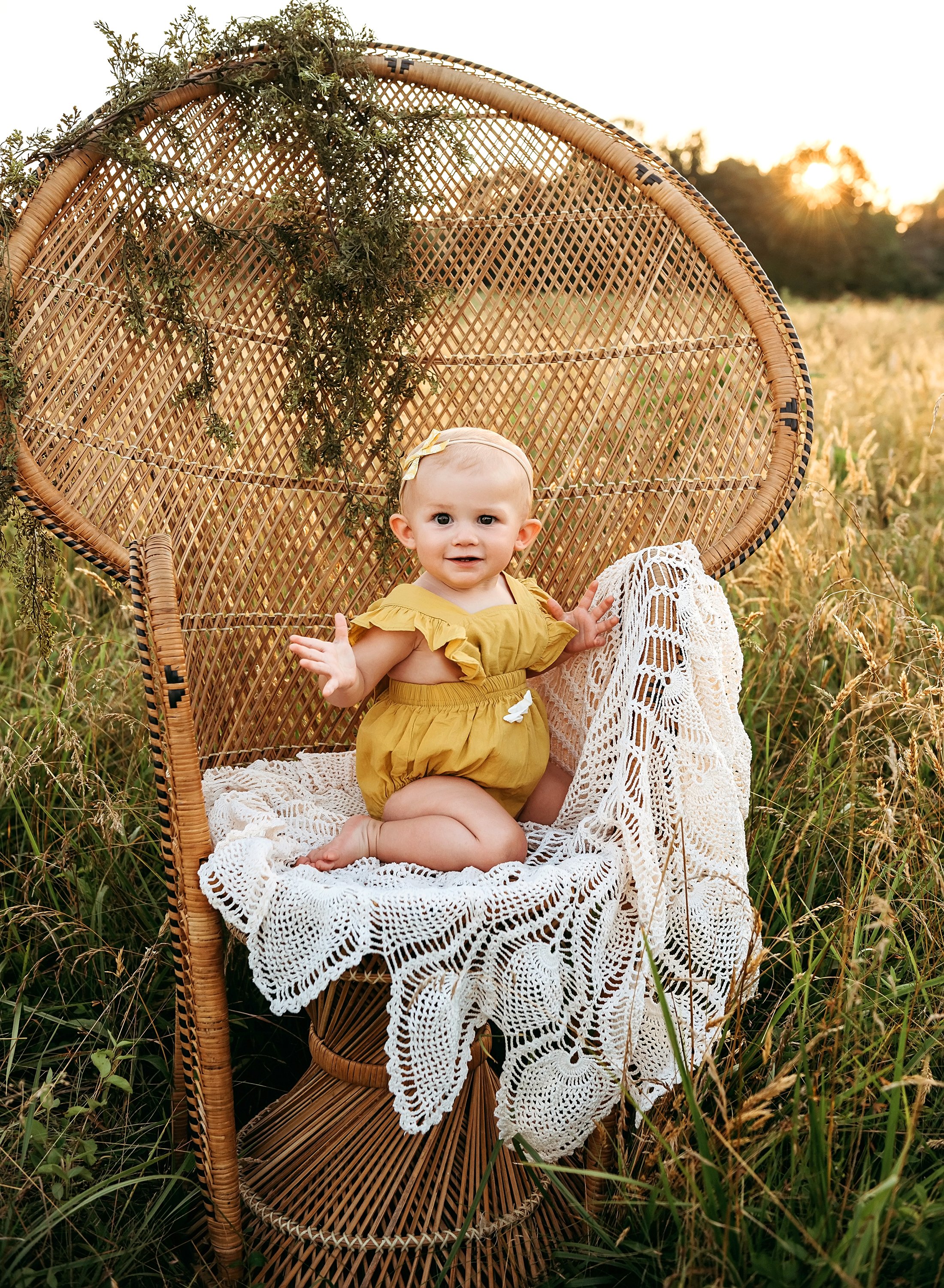 baby girl standing on chair smiling.jpg