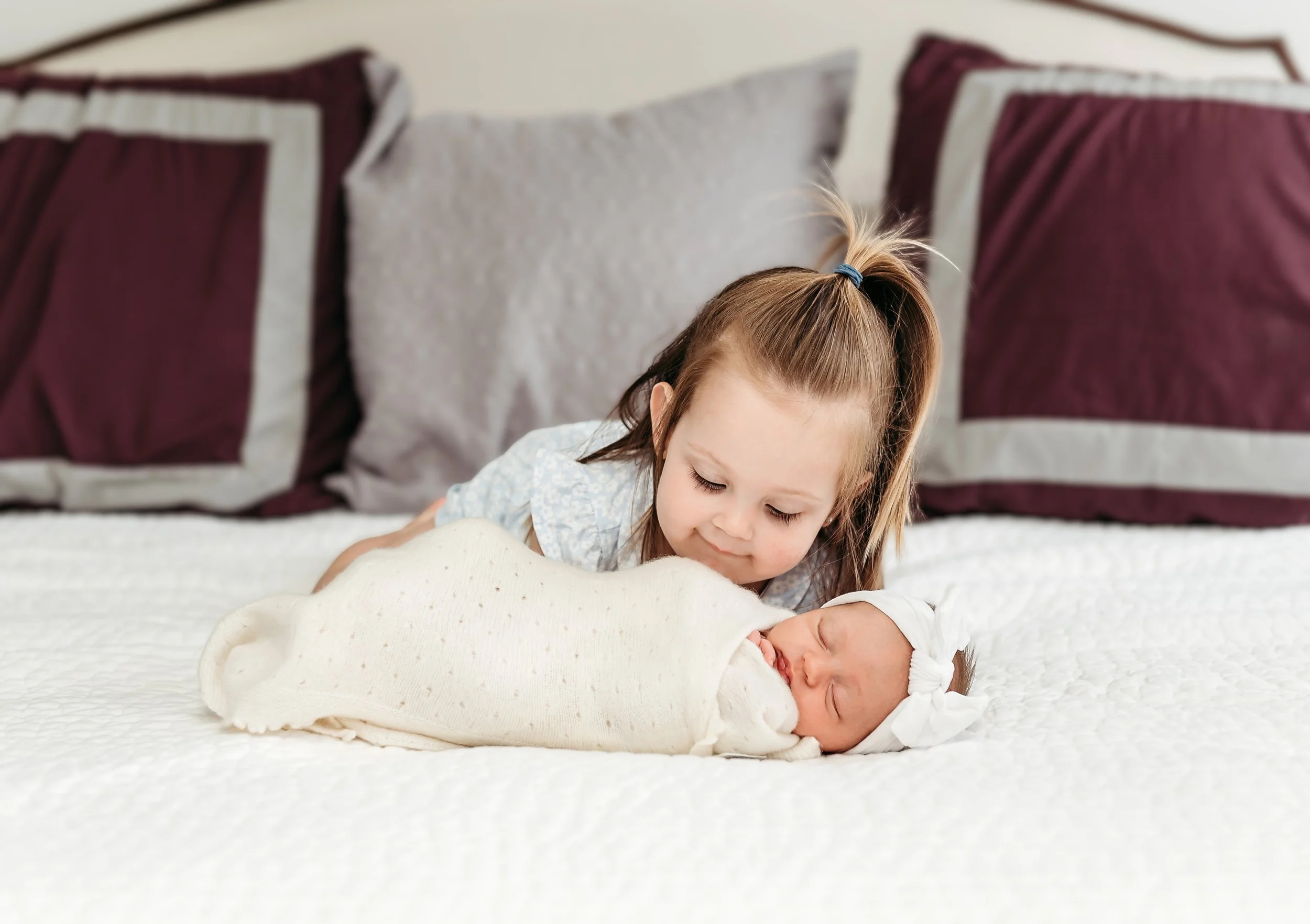little girl with baby wrapped up.jpg