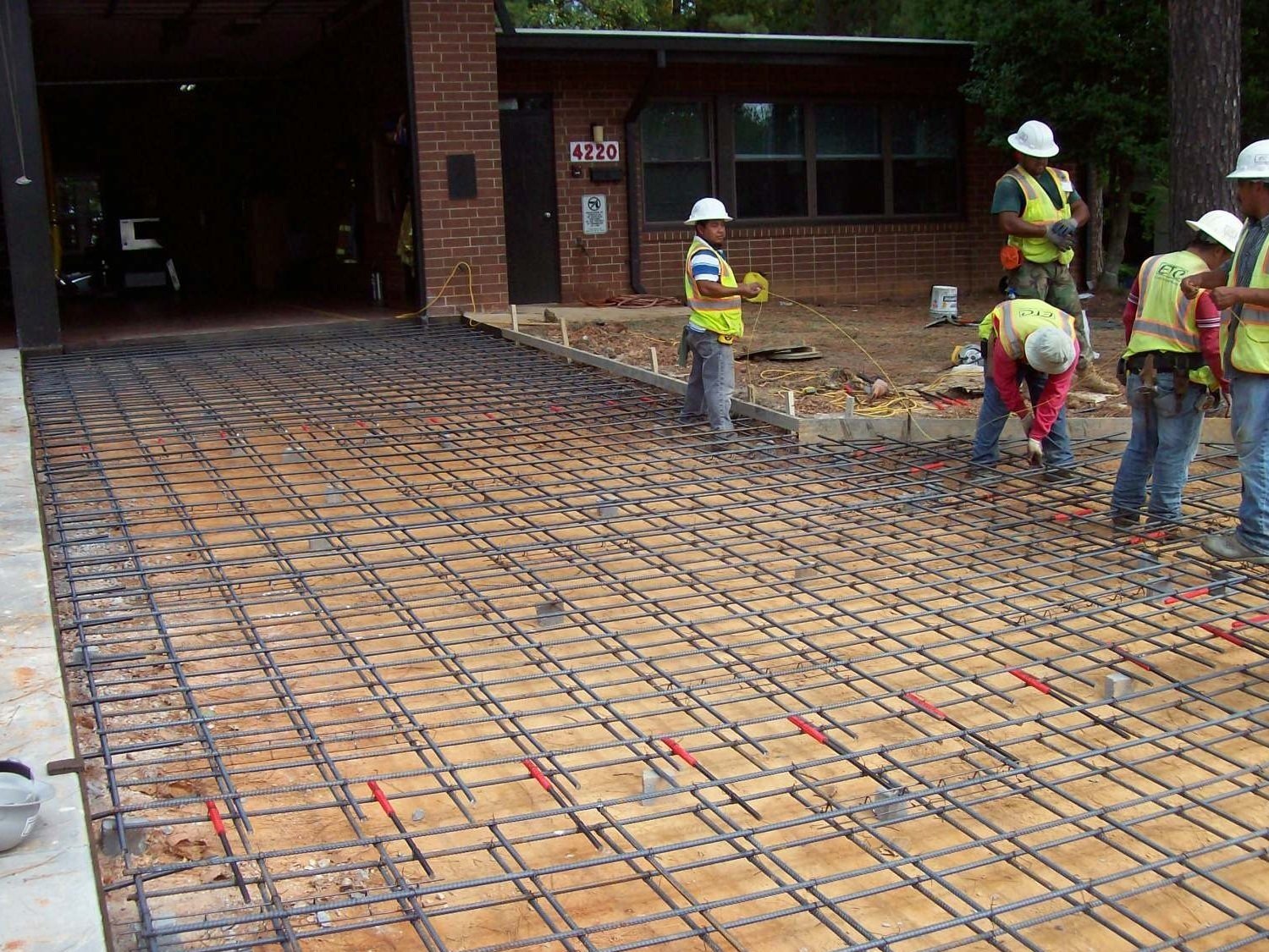 Workers prepare rebar for concrete on Raleigh fire station driveway