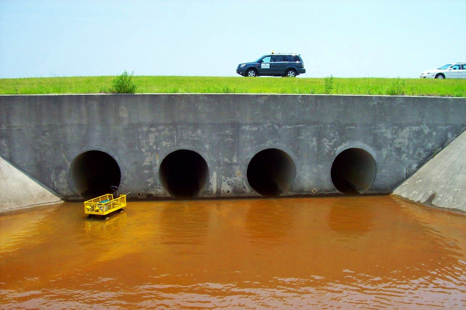 Four pipe culverts under a roadway
