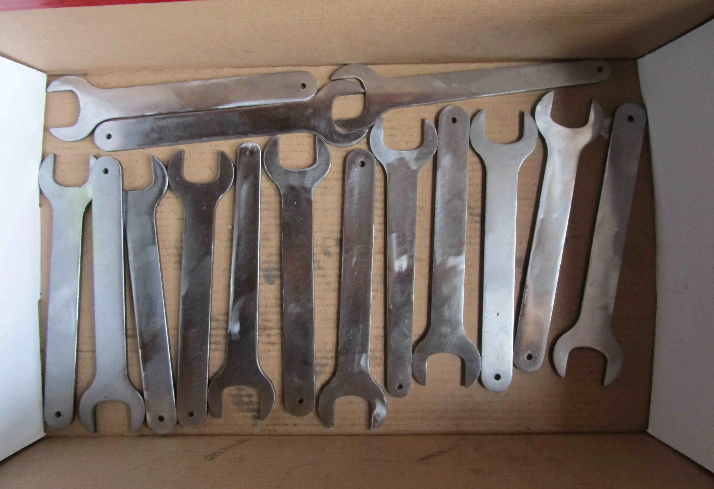 Laser cut and milled HT steel blanks have been drilled for feeler gauge, and ground ready for polishing